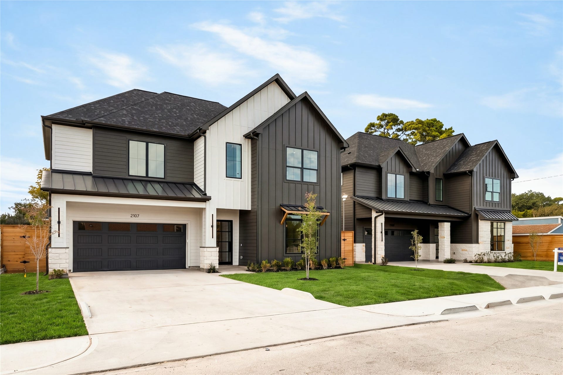 2107 McKean Drive, Houston, TX 77080 A wider view captures the homes distinctive modern profile and layered rooflines, with a broad driveway and landscaped front lawn creating an impressive sense of arrival.