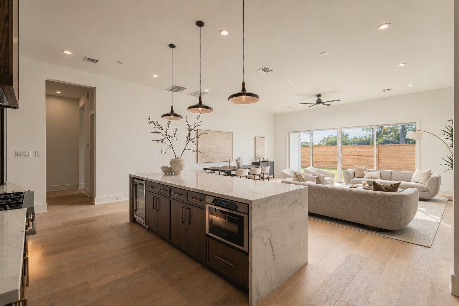 2107 McKean Drive, Houston, TX 77080 Designed for connection, the kitchen opens effortlessly into the main living area, with the expansive island creating a natural gathering place at the heart of the home.