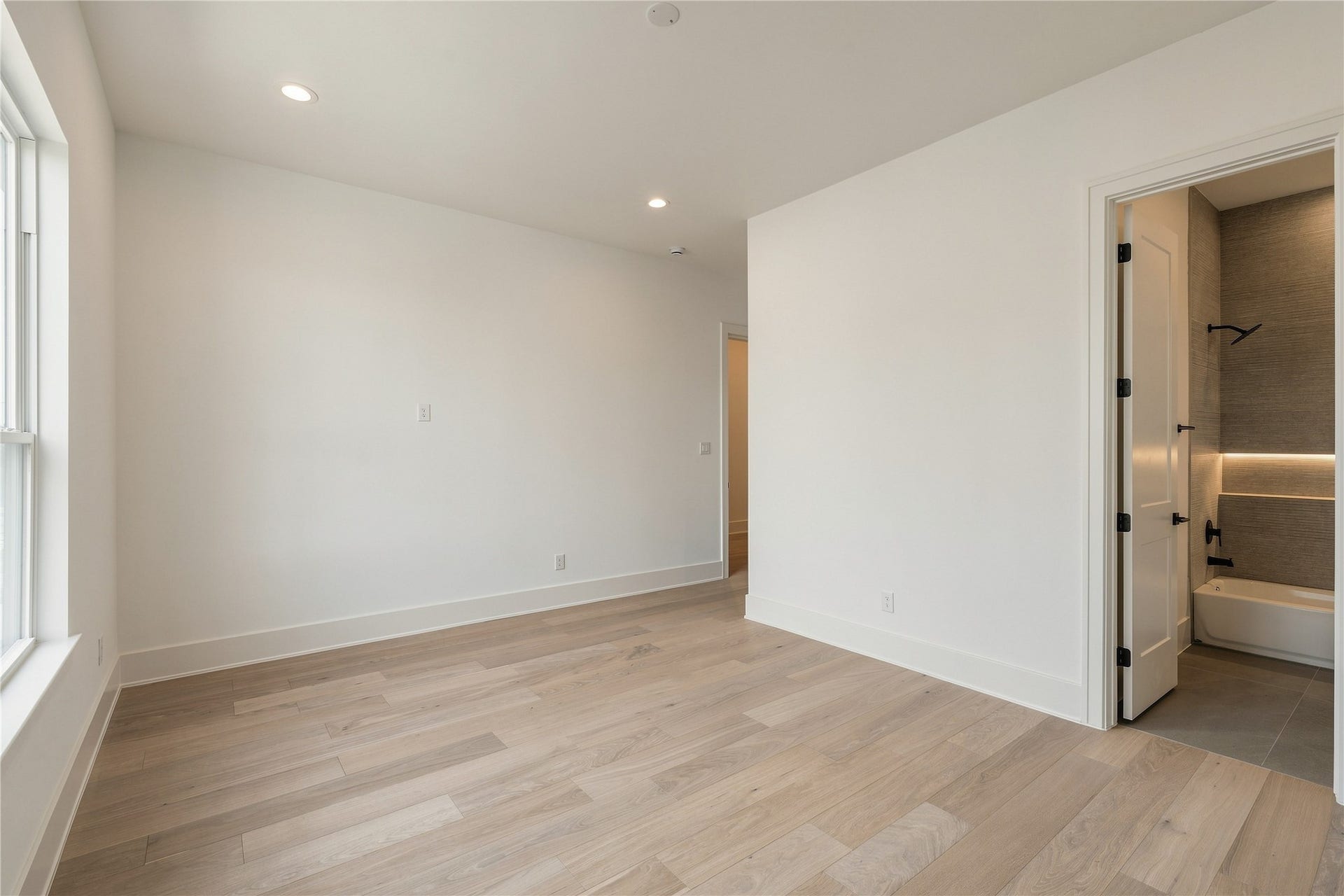 2107 McKean Drive, Houston, TX 77080 A second perspective reveals the bedrooms walk-in closet and generous floor space, allowing for multiple furniture configurations without compromising the rooms openness.