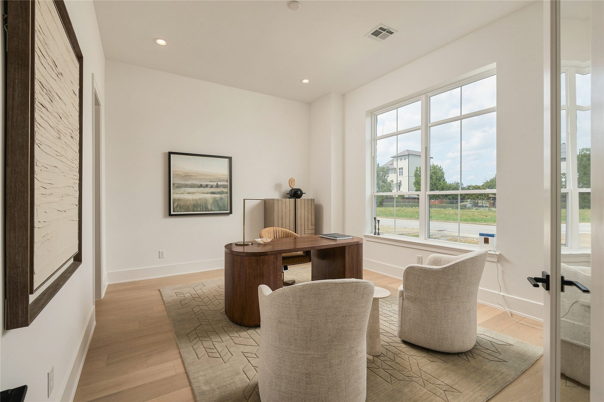 2107 McKean Drive, Houston, TX 77080 A dedicated home office is filled with natural light, offering a polished and private setting for work, meetings, or quiet focus.
