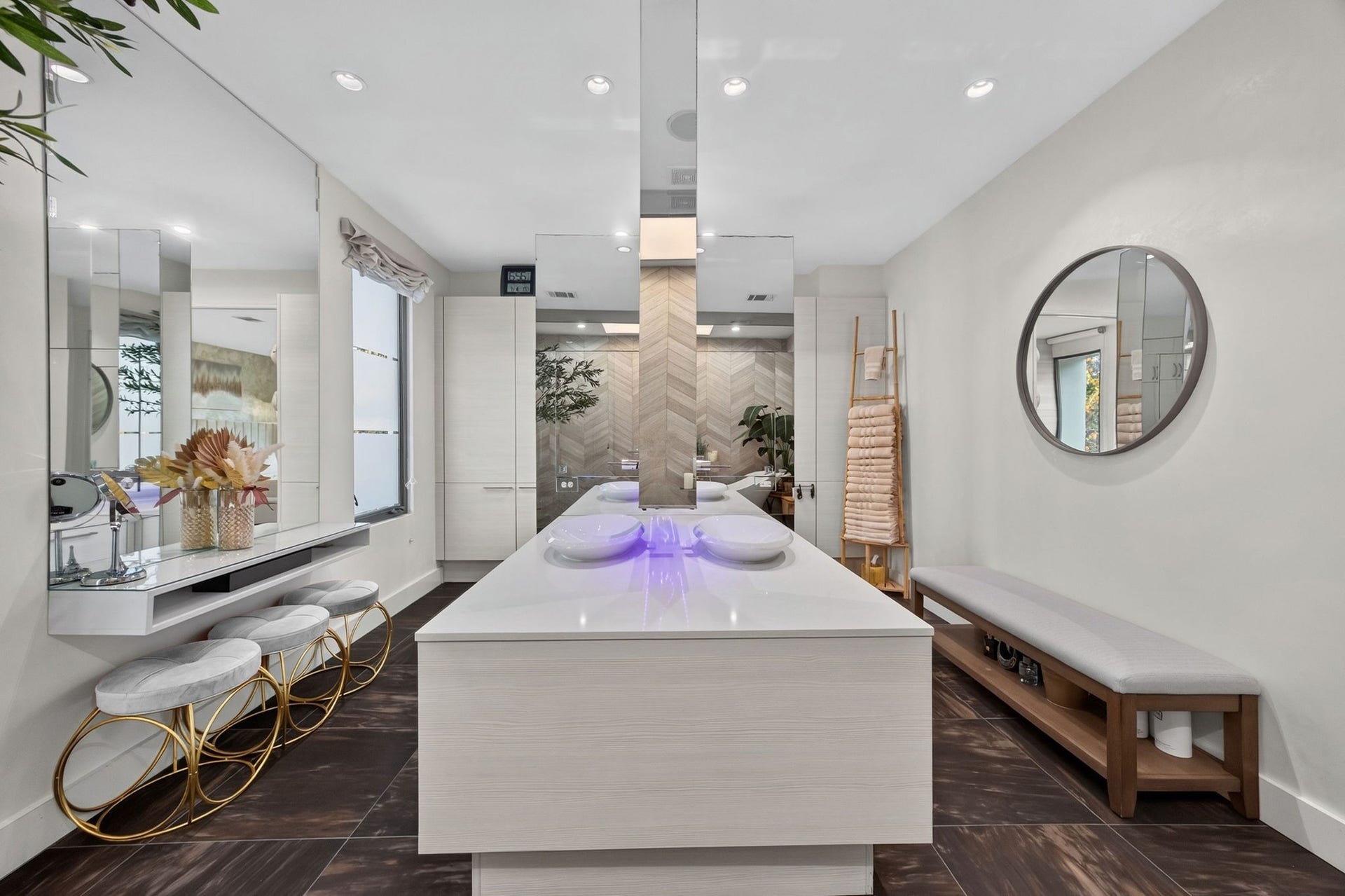 1310 Nantucket Drive, Houston, TX 77057 Luxurious bathroom featuring a sleek double vanity with vessel sinks, elegant modern mirrors, and ample storage. The space is accentuated with sophisticated lighting and chic seating, creating a spa-like retreat.