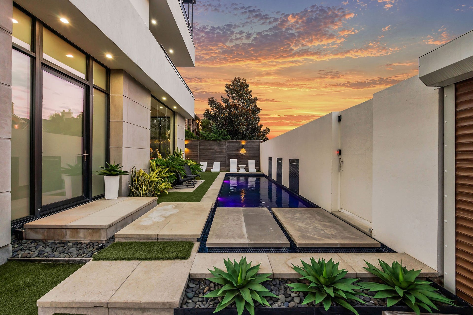 1310 Nantucket Drive, Houston, TX 77057 Luxurious modern home with a stunning pool area, featuring sleek landscaping and ambient lighting, perfect for evening relaxation.