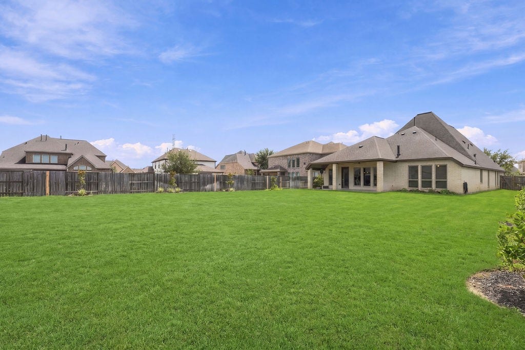 6914 Red Oak Drive, Katy, TX 77493 Expansive backyard with lush green lawn, perfect for outdoor activities and entertaining, set in a tranquil neighborhood.