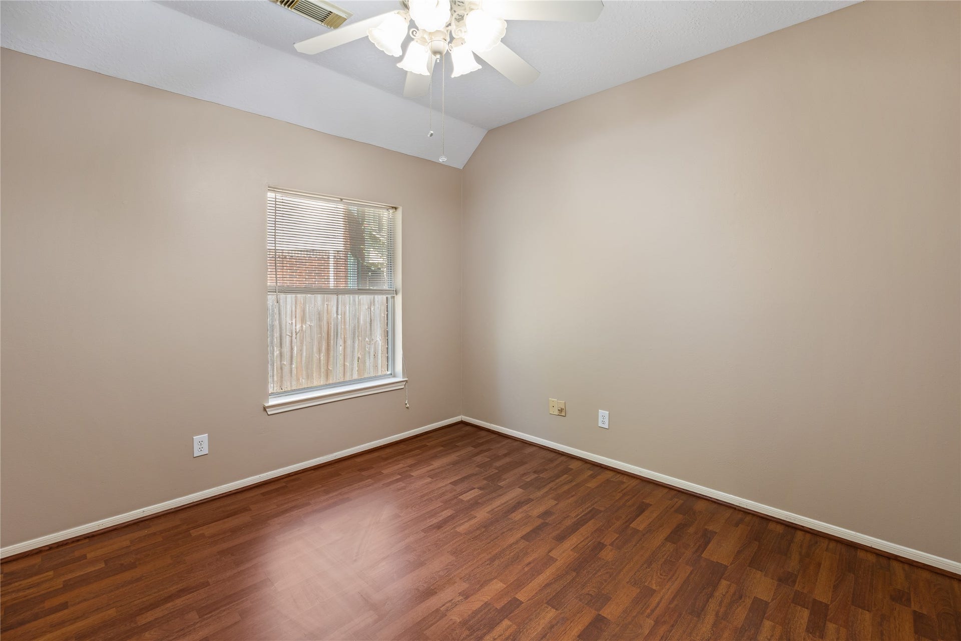 16926 Cobbler Crossing Drive, Sugar Land, TX 77498 Warm wood look laminate flooring, a vaulted ceiling and lots of soft natural light make this guest bedroom feel open and inviting. A large closet adds practical storage, while the nearby full bathroom brings everyday convenience.