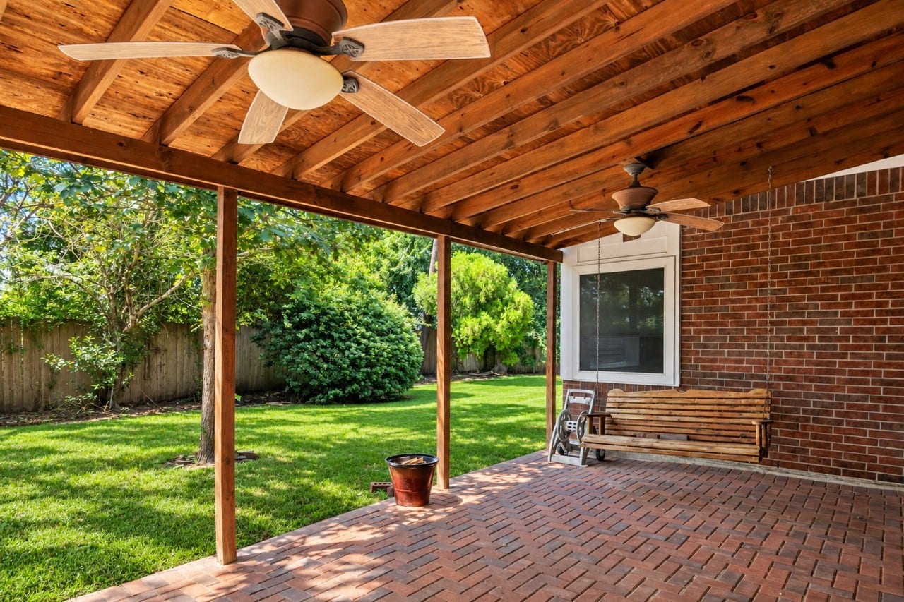 16926 Cobbler Crossing Drive, Sugar Land, TX 77498 This covered brick patio is ready for slow mornings, casual dinners and evenings spent outside, with ceiling fans overhead and plenty of shade for more comfortable outdoor living.