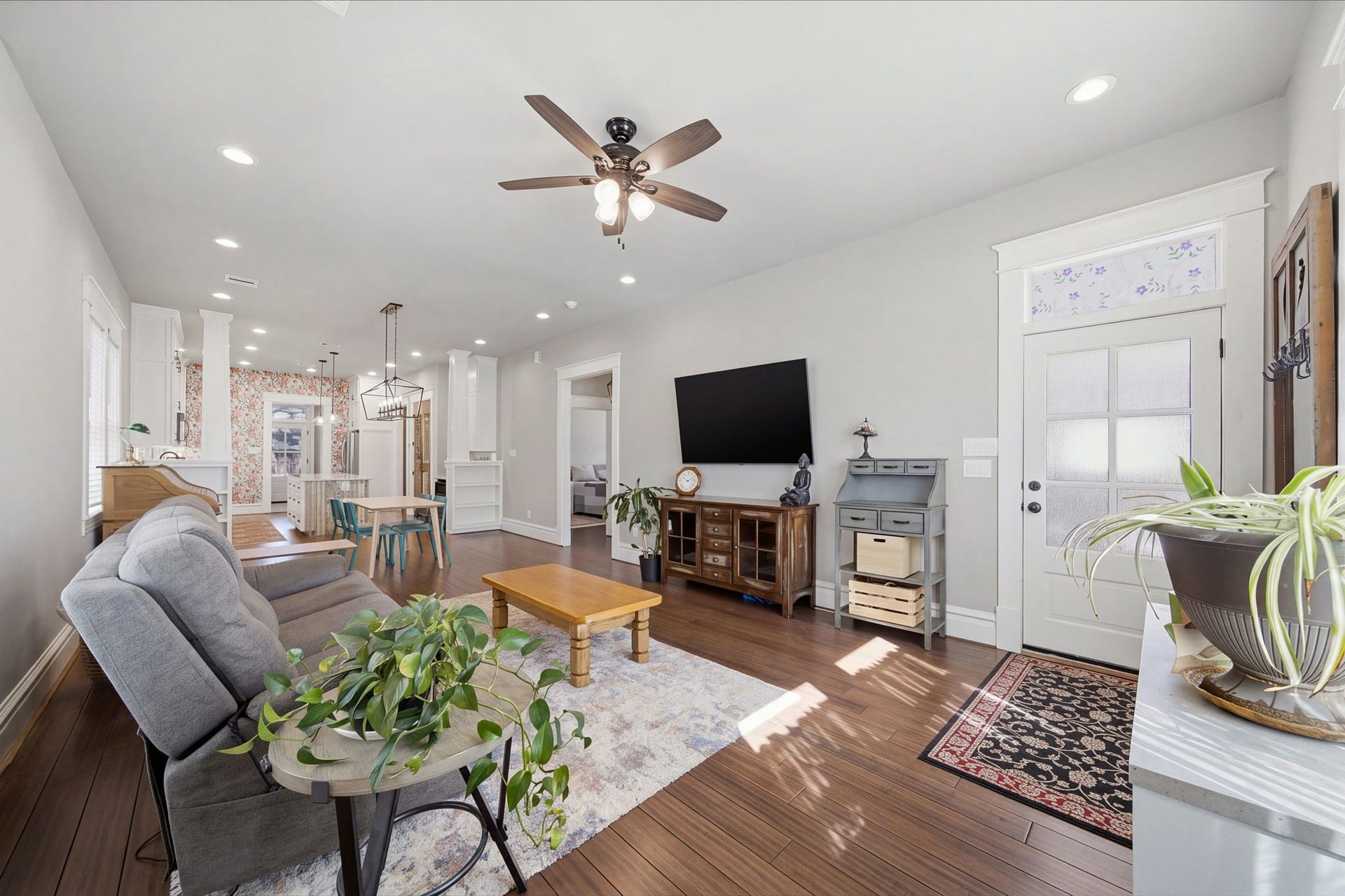 Walk through the front door into the LIVING ROOM. Transom window above the front door! SOLID BAMBOO floors and TALL 10' ceilings throughout the home! No carpet!