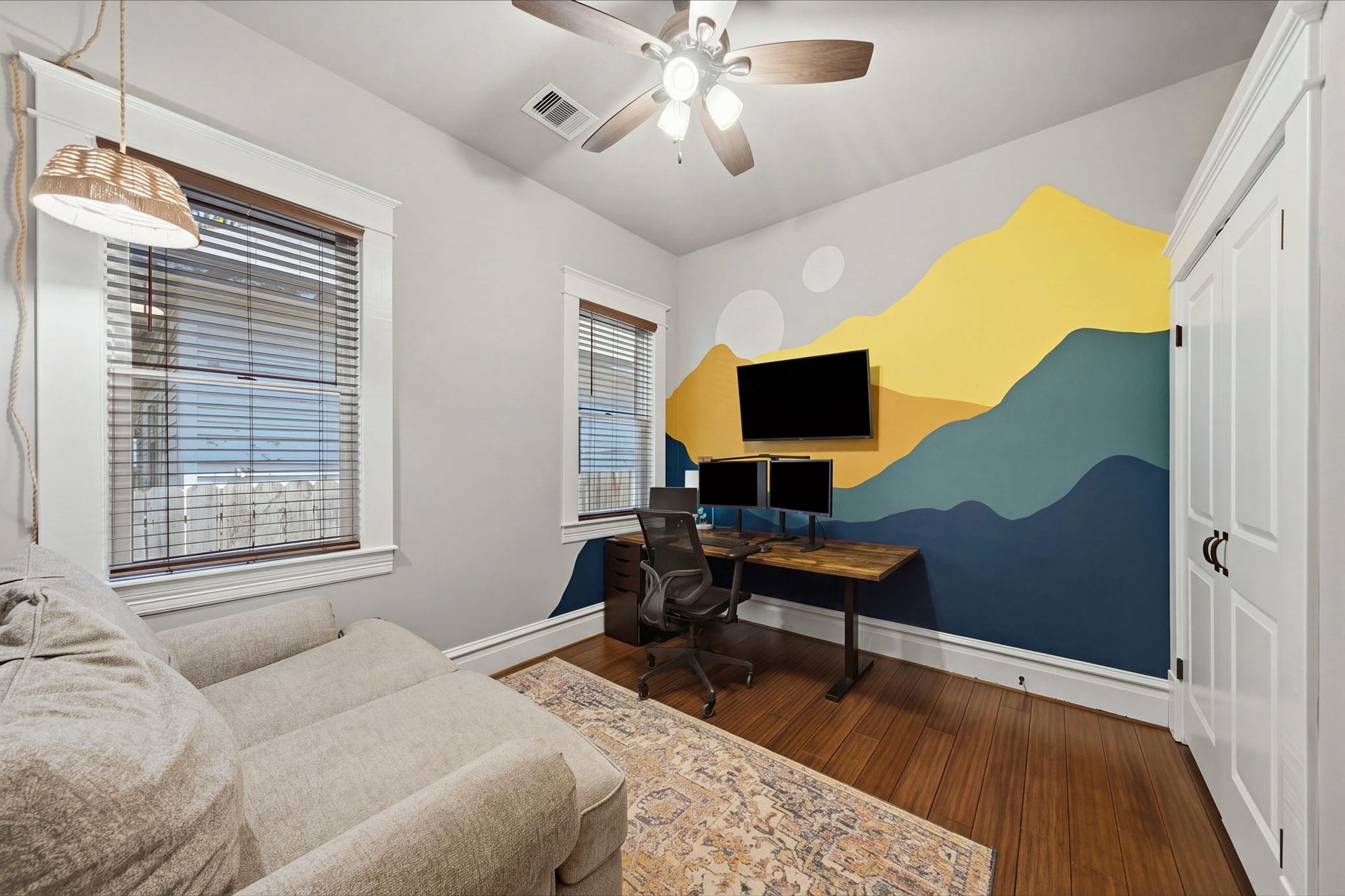 This is the guest bedroom (of 3) closest to the primary bedroom. Currently used as an office! Double door closet has been converted into a craft space! Handpainted mural!