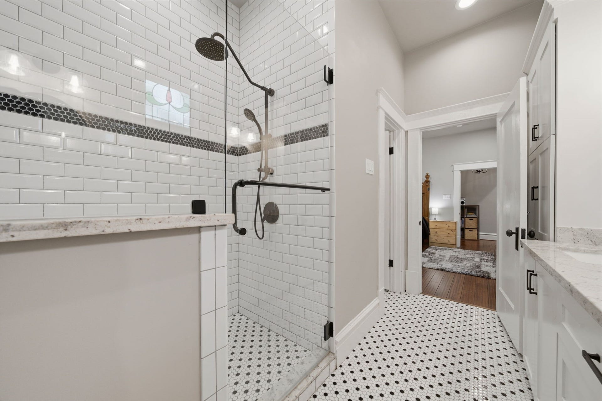 Primary bath - frameless glass doors into the shower area with a granite-topped bench (not pictured!) There is also a large linen closet and WC room ini this primary bath!