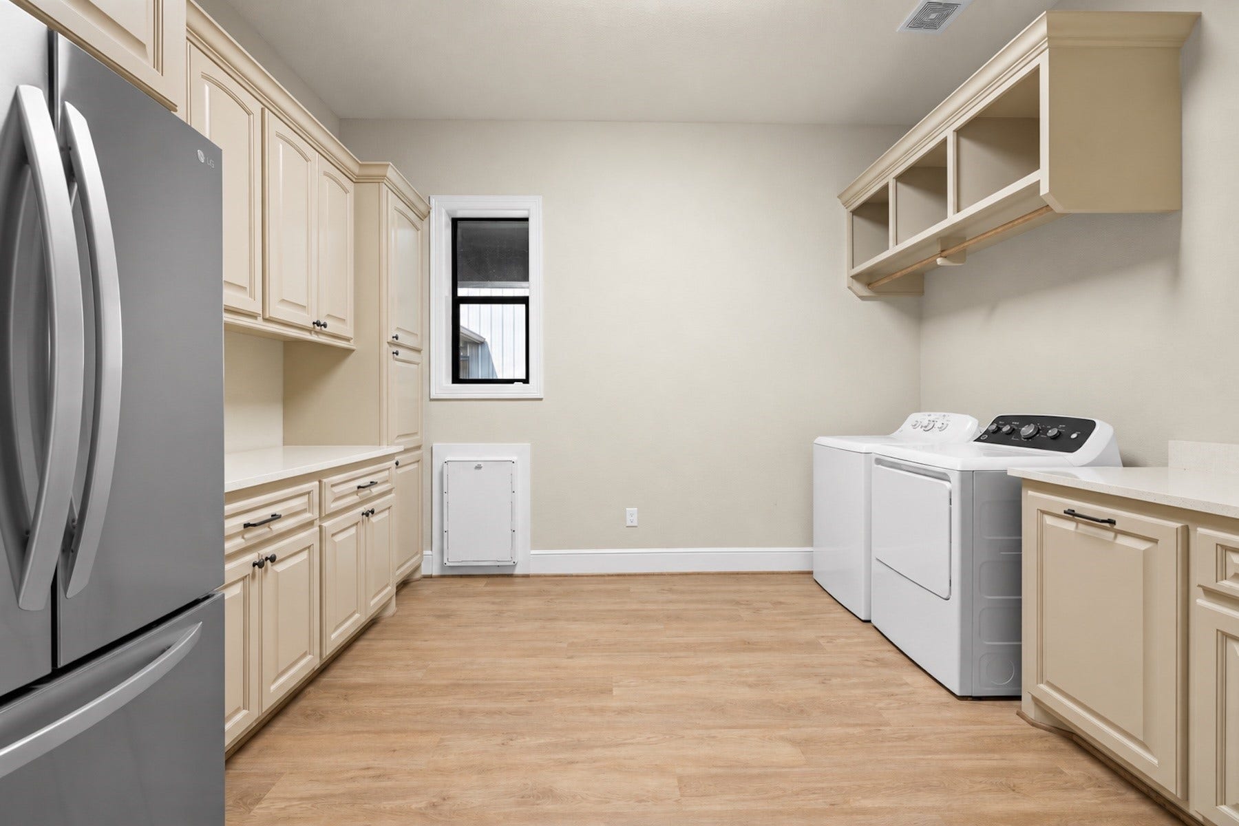 30163 High Spirit Ranch Road, Hempstead, TX 77445 The in house utility room has a full size refrigerator and ample storage.