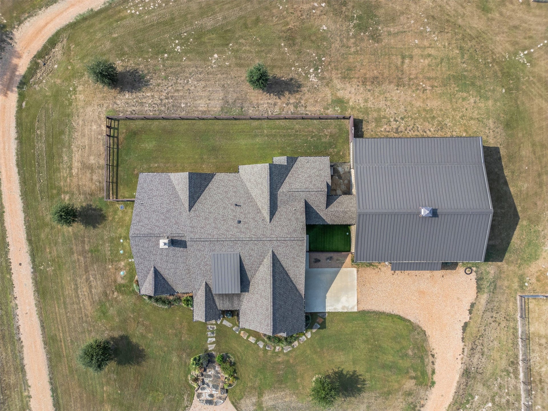 30163 High Spirit Ranch Road, Hempstead, TX 77445 Aerial shot above the house- the barn to the right is attached to the main residence.