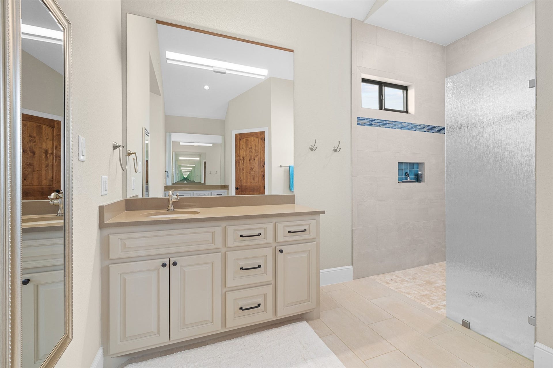 30163 High Spirit Ranch Road, Hempstead, TX 77445 Primary ensuite bath offers dual vanities, large walk-in shower with privacy glass wall and accessibility for wheelchair access.
