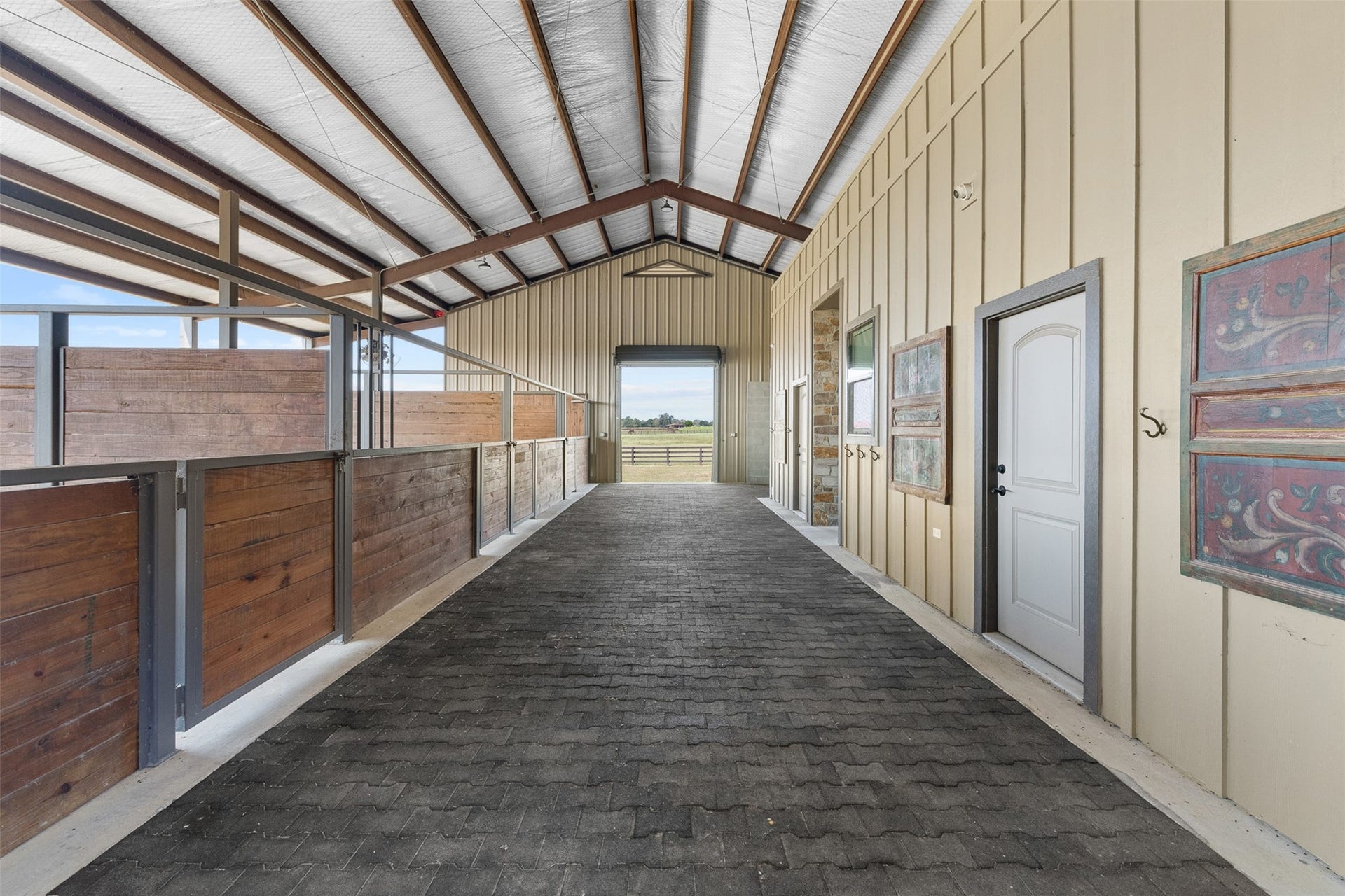 30163 High Spirit Ranch Road, Hempstead, TX 77445 The breezeway of the barn allows for plenty of open air and light to flow in.