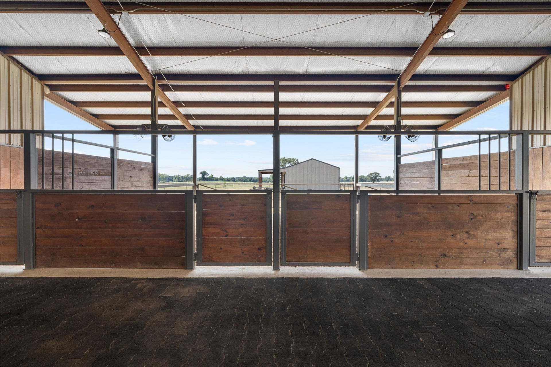 30163 High Spirit Ranch Road, Hempstead, TX 77445 4 stalls line up next to each other in the barn.
