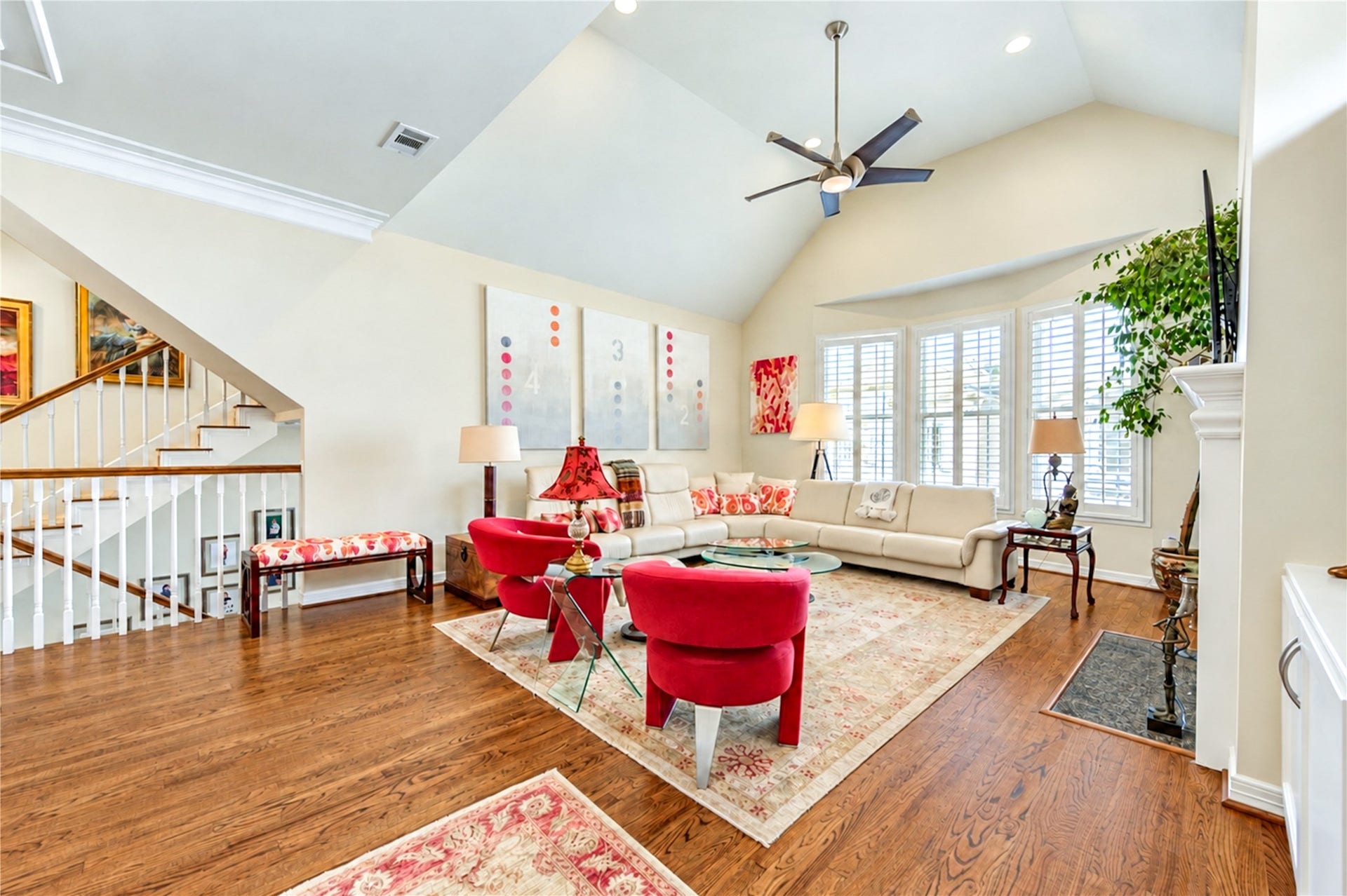 4 Milan Estates, Houston, TX 77056 Soaring vaulted ceilings, expansive shuttered windows and rich hardwood floors create a bright, inviting second-floor living room.