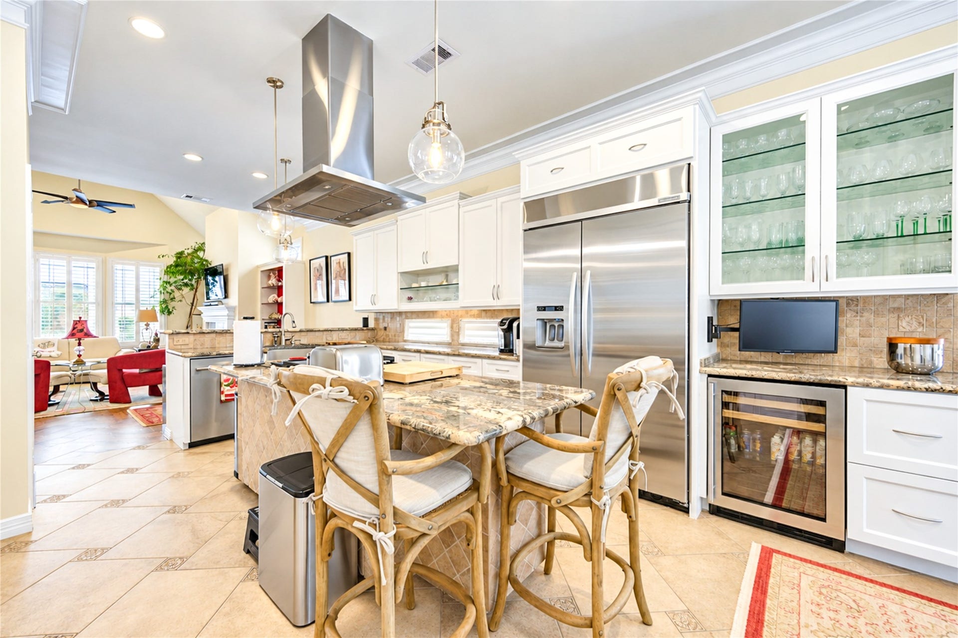 4 Milan Estates, Houston, TX 77056 A built-in Sub-Zero refrigerator and a wine refrigerator anchor the kitchen, which offers glass-front cabinetry, granite surfaces and abundant natural light.