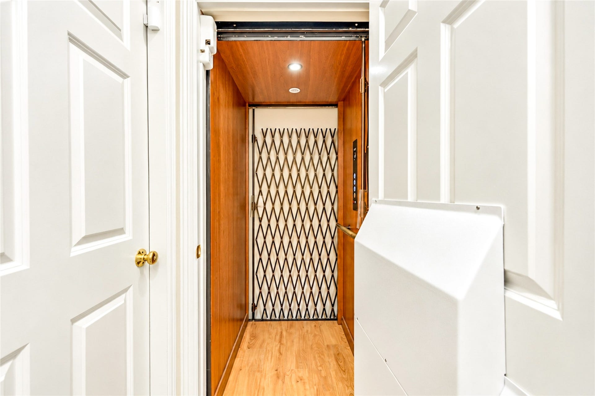 4 Milan Estates, Houston, TX 77056 A wood-paneled elevator with a decorative scissor gate serves all three levels of the home.
