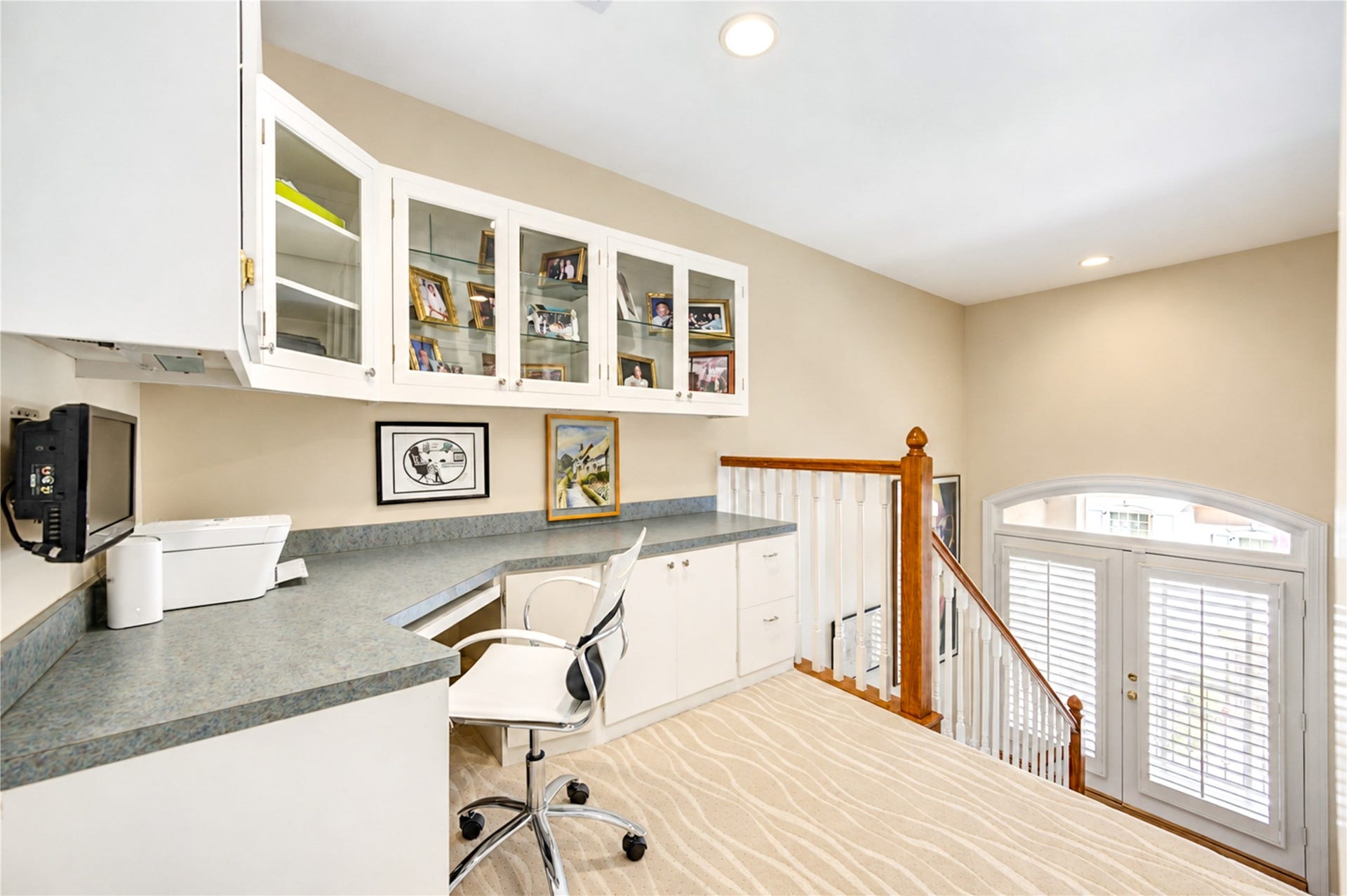 4 Milan Estates, Houston, TX 77056 A beautifully designed third-floor office features a custom built-in desk, generous workspace and elegant glass-front cabinetry.