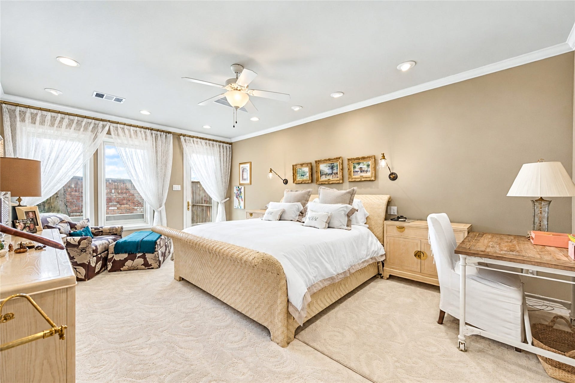 4 Milan Estates, Houston, TX 77056 The first-floor primary bedroom is a spacious retreat with recessed lighting, crown molding, a ceiling fan and windows that fill the room with natural light.