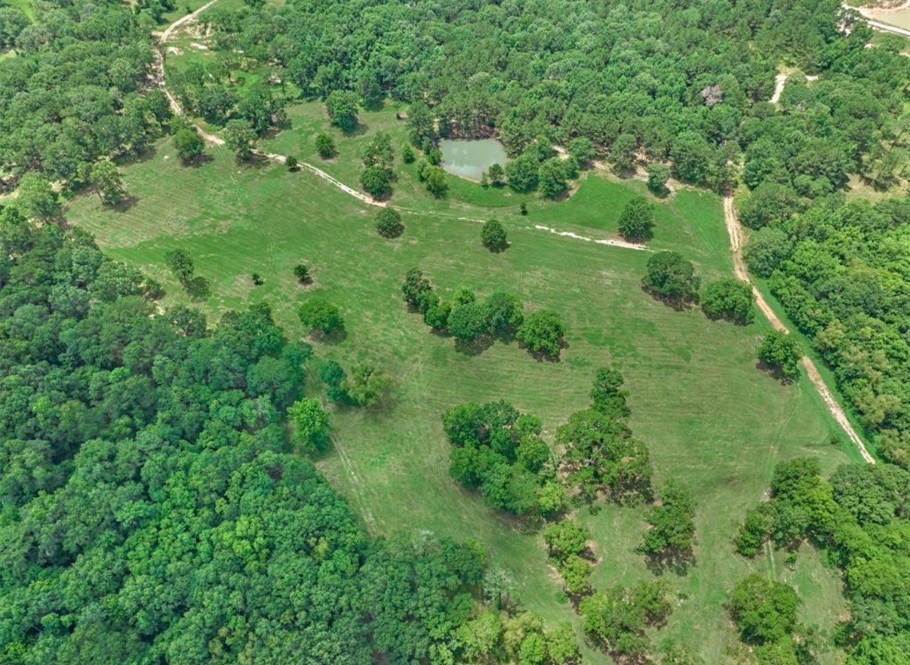 Tract B Sharpwest Trail, Montgomery, TX 77316 Expansive 33.51 acres with rolling hills, mature trees, and two serene ponds, offering a perfect setting for a private retreat or ranch.