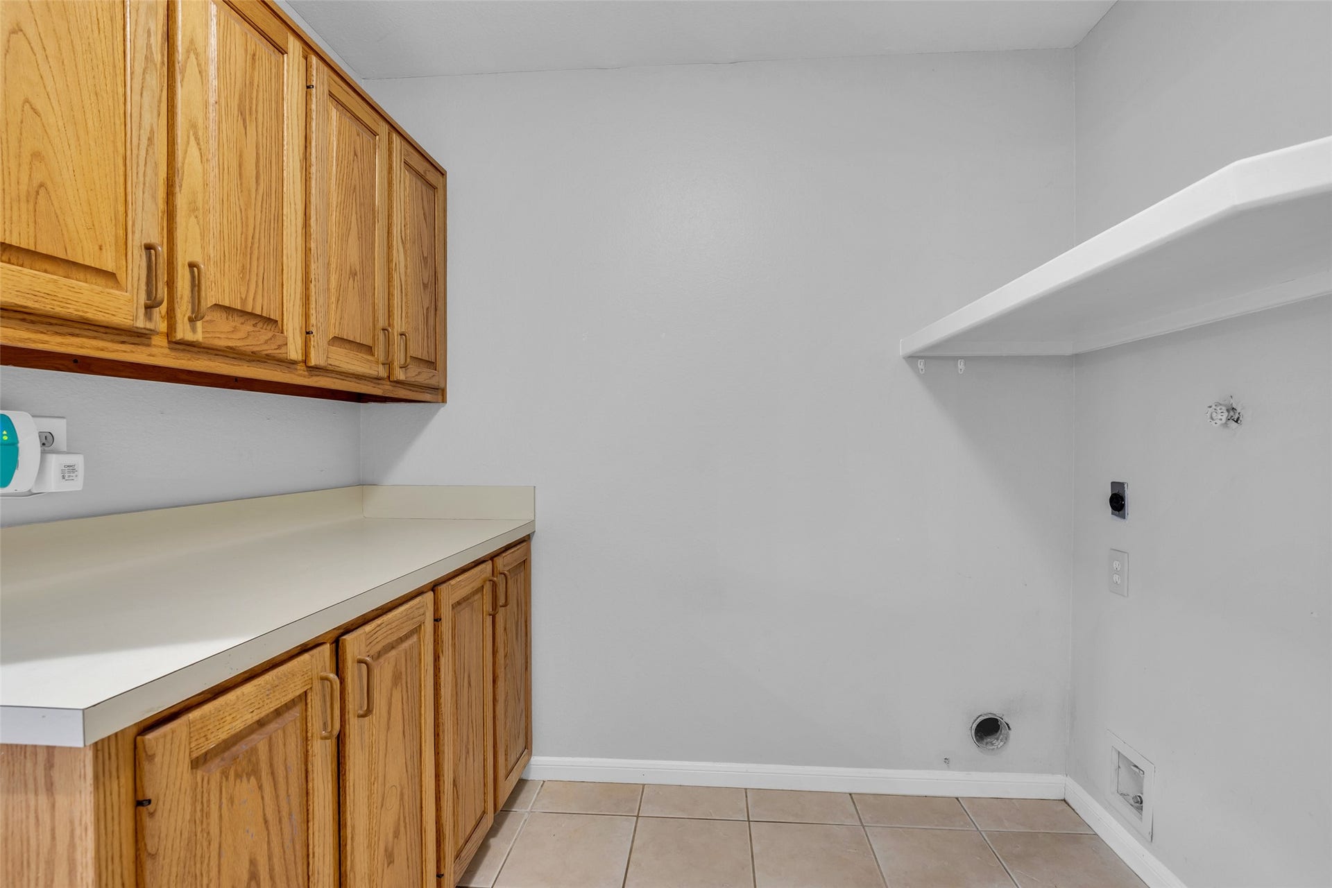 54 Sky Terrace Place, The Woodlands, TX 77381 Spacious interior laundry room featuring ample cabinetry, a convenient countertop workspace, washer and dryer hookups, and direct access to the garage.