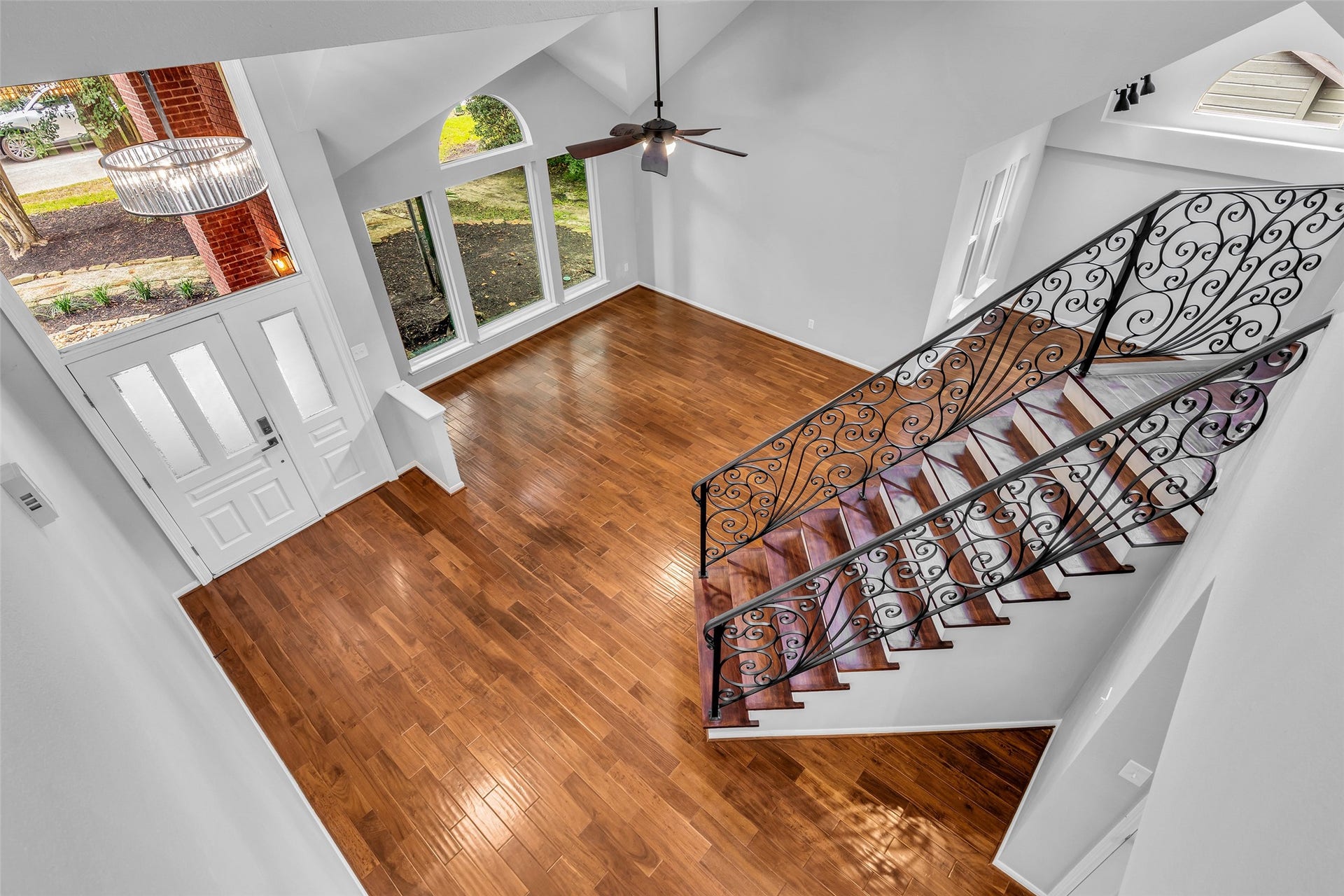 54 Sky Terrace Place, The Woodlands, TX 77381 View from the second floor overlooking the elegant entryway, showcasing the open living spaces below and the abundance of natural light throughout the home.