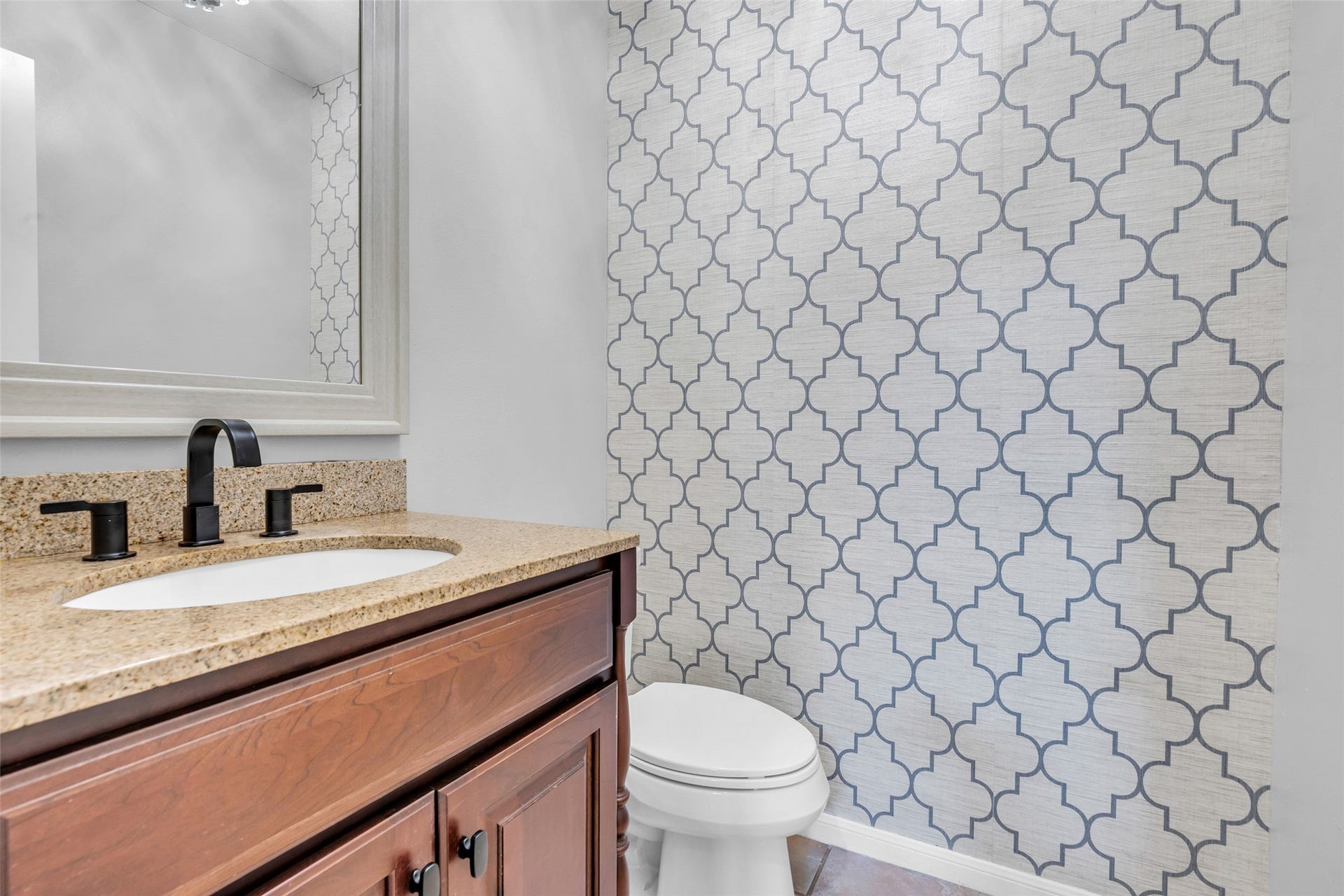 54 Sky Terrace Place, The Woodlands, TX 77381 Conveniently located powder room, perfect for guests, featuring a granite countertop and modern fixtures.