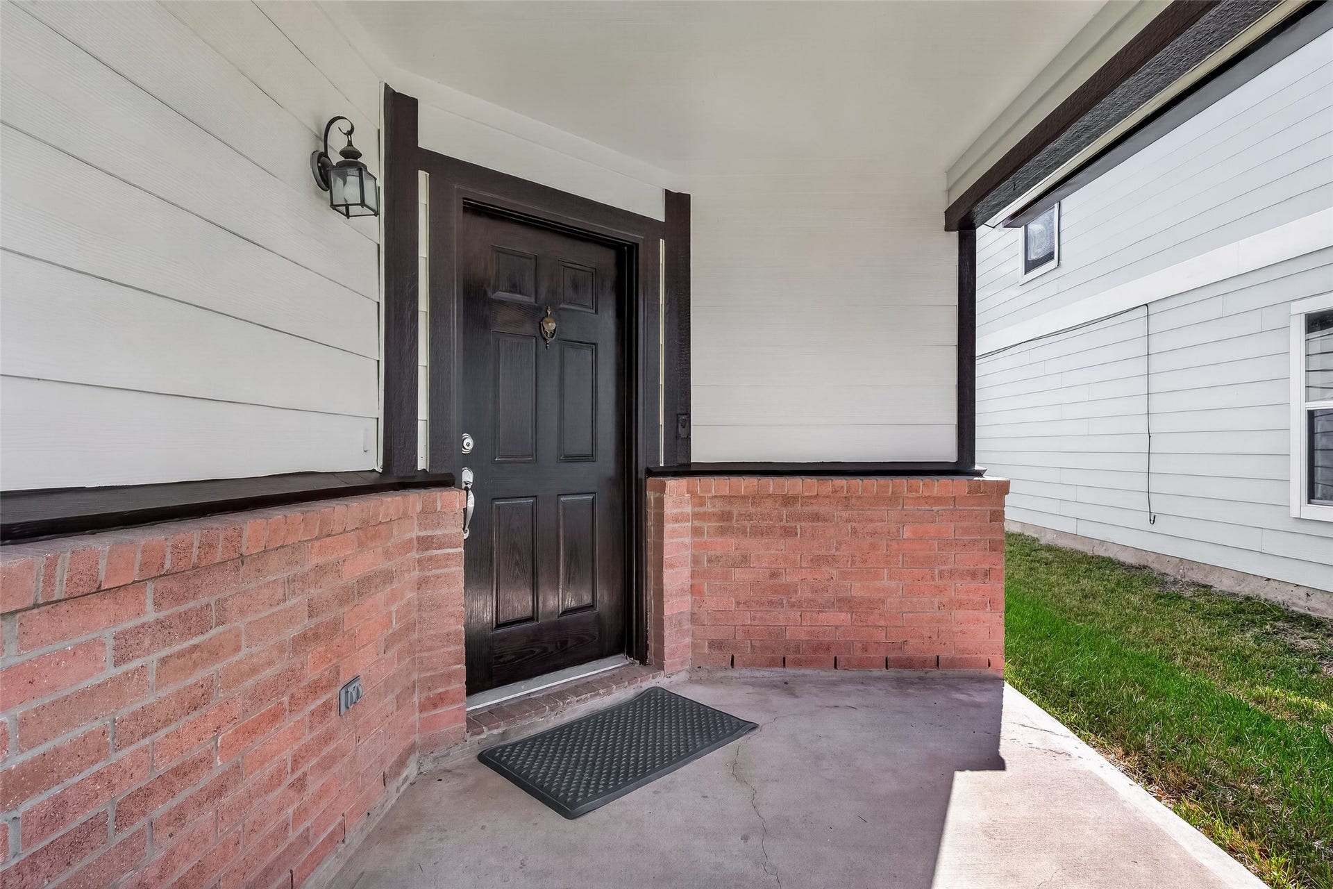 2662 Skyview Glen Court, Houston, TX 77047 A closer look at the covered front entrance reveals a clean combination of brick and siding, giving the facade depth and a polished, well-kept appearance.
