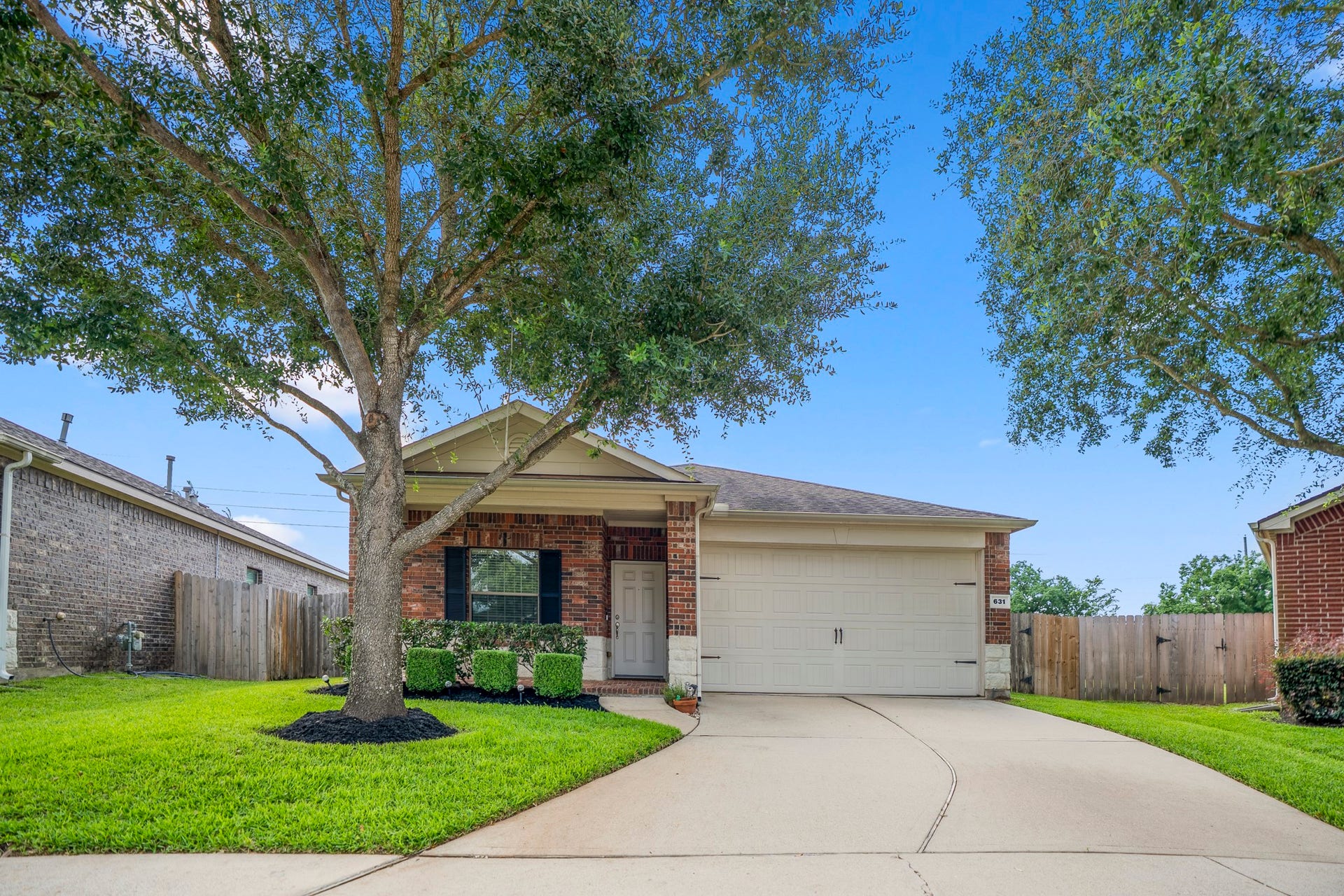 631 E Newport Bend, Katy, TX 77494 Welcome to 631 E Newport Bend in gated Grand Enclave, where a large shade tree, fresh landscaping, and a covered front entry create an inviting first look.