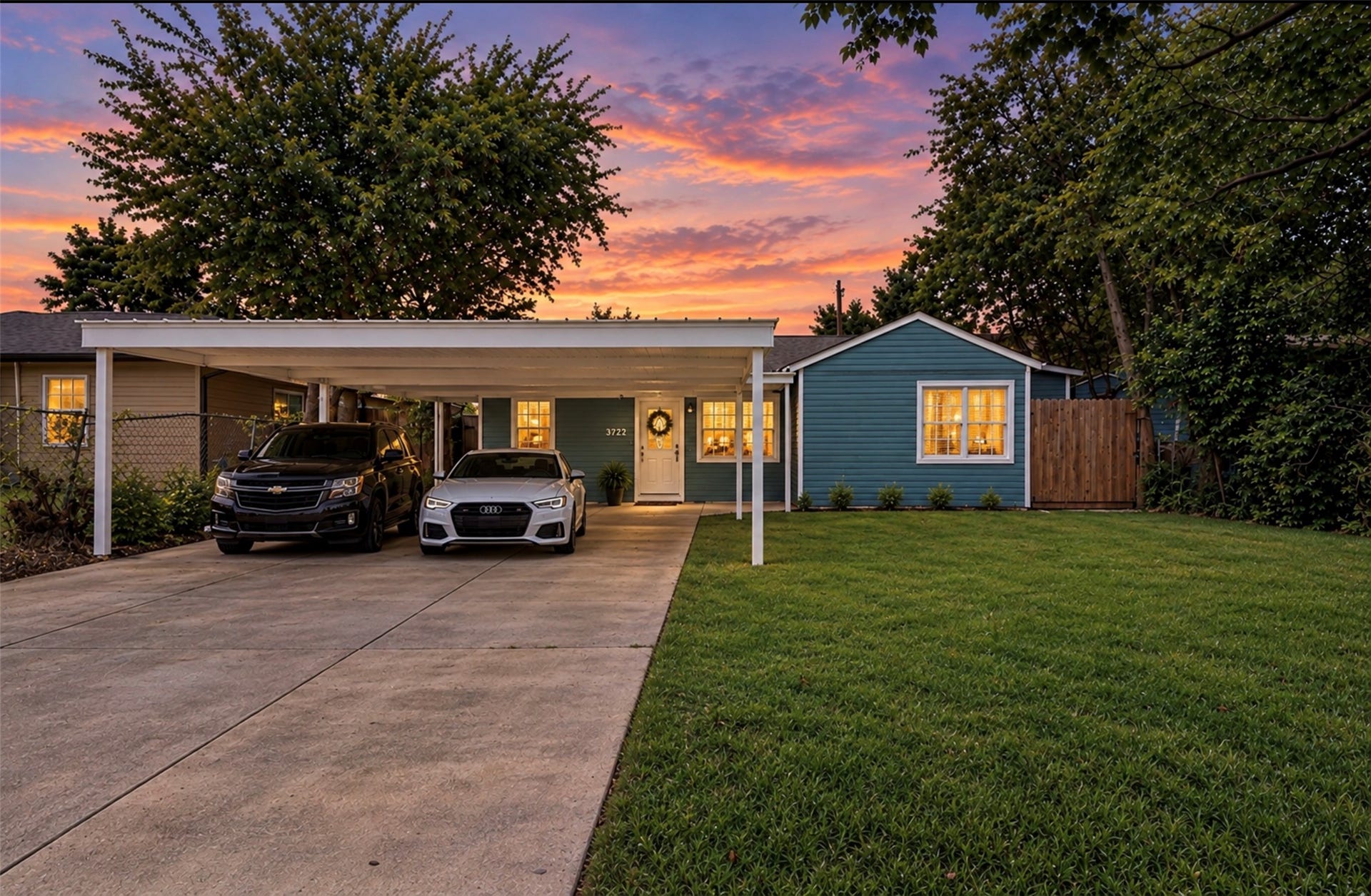 6638 Thornwall Street, Houston, TX 77092 Photoshopped/Enhanced Photo (twilight): Front view of this beautifully remodeled home showcasing ample driveway parking and a covered carport, providing convenient shade and protection from the Texas sun while helping keep the front of the home cooler.
