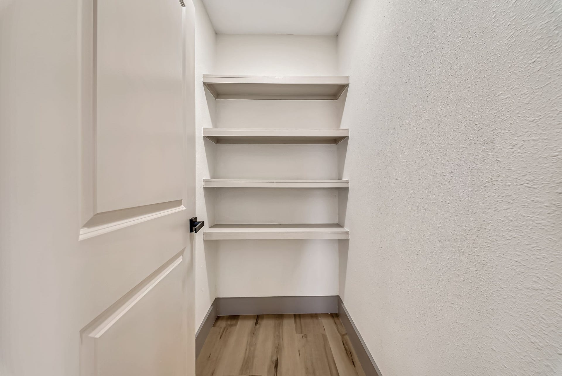 6638 Thornwall Street, Houston, TX 77092 Walk- in pantry with built-in shelving, perfect for organizing essentials.