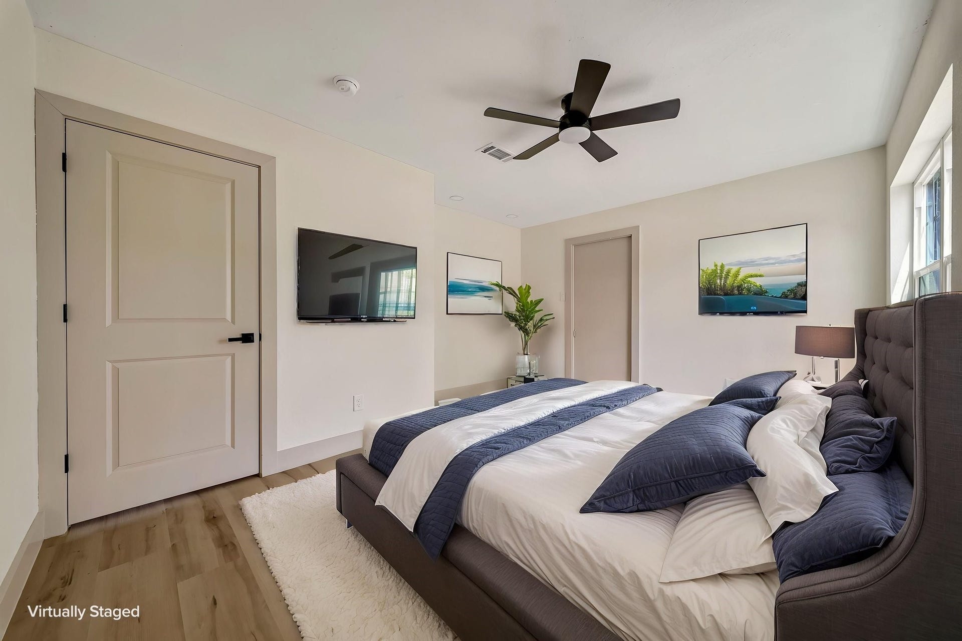6638 Thornwall Street, Houston, TX 77092 (Photoshopped) Experience modern elegance in this virtually staged bedroom, featuring a sleek ceiling fan, stylish furnishings, and abundant natural light that creates a serene retreat.
