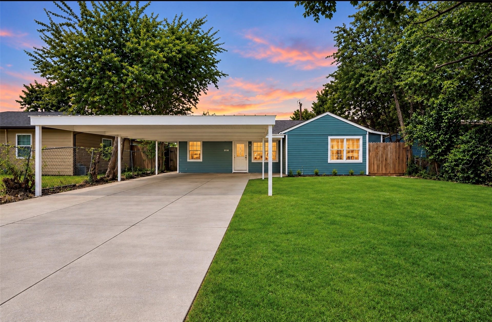 6638 Thornwall Street, Houston, TX 77092 Photoshopped/Enhanced Photo: Front view of this beautifully remodeled home showcasing ample driveway parking and a covered carport, providing convenient shade and protection from the Texas sun while helping keep the front of the home cooler.