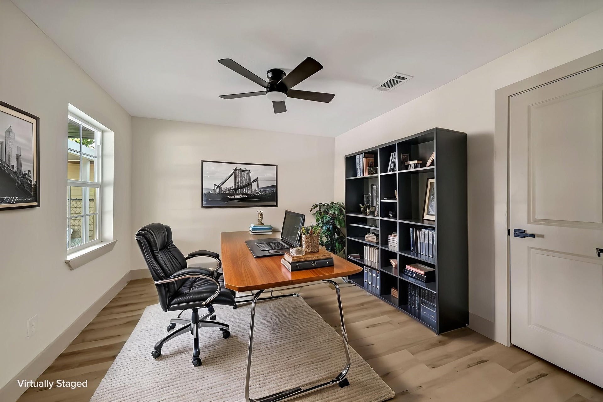 6638 Thornwall Street, Houston, TX 77092 (Photoshopped) This elegantly staged home office/possibility of a 4th bedroom features abundant natural light, sleek modern furnishings, and a spacious bookshelf, creating an inspiring workspace.