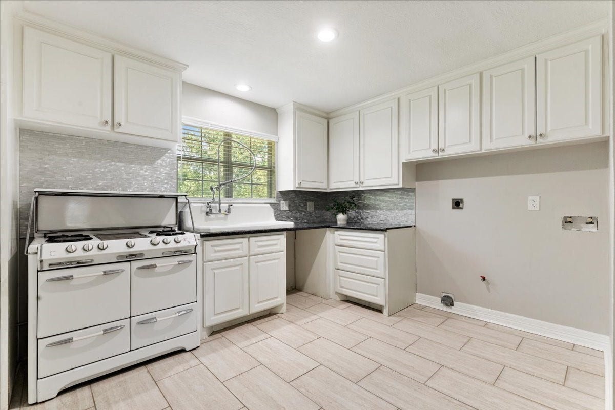 6327 Westcreek Drive, Brookside, TX 77581 One of this home's standout features! The private suite includes its own full kitchen with white cabinetry, stove, sink, and generous storageproviding convenience and independence