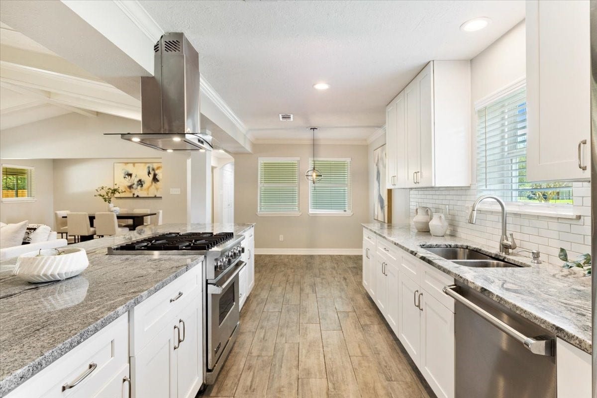 6327 Westcreek Drive, Brookside, TX 77581 Beautifully designed kitchen featuring white cabinetry, granite countertops, stainless steel appliances, and a gas cooktop. The open layout makes entertaining effortless!