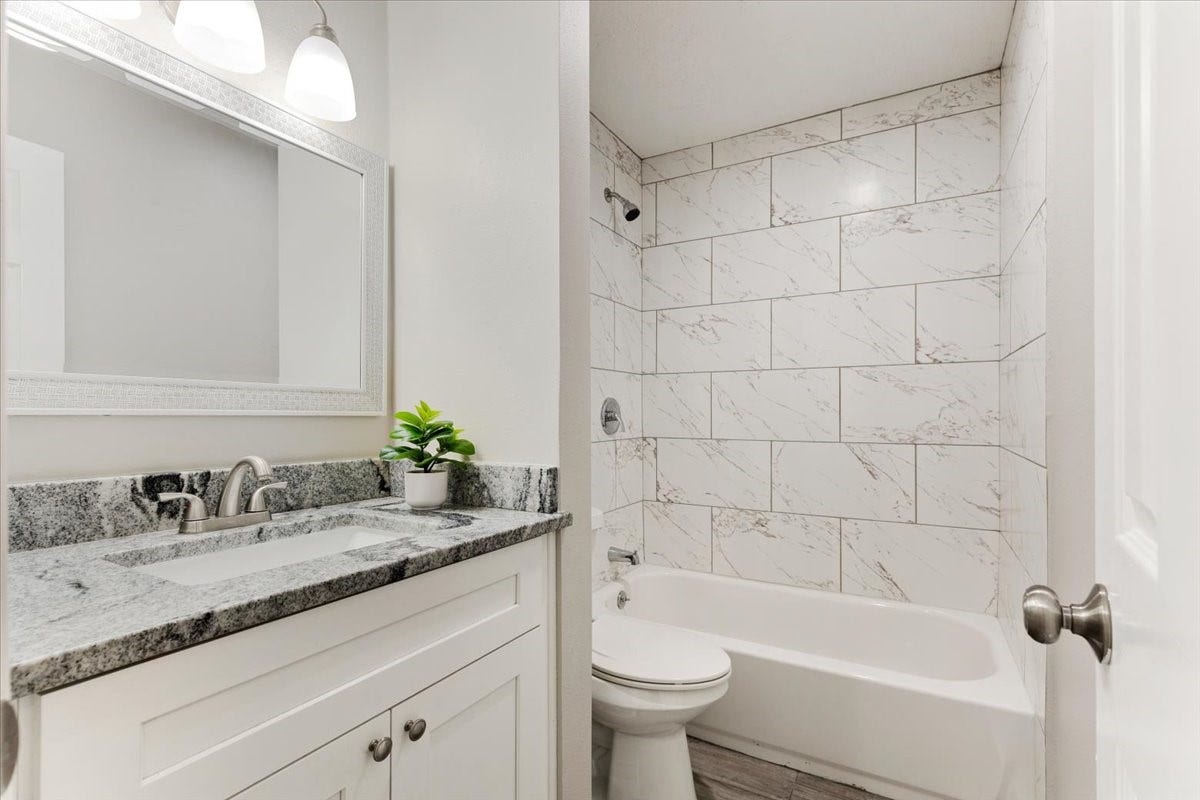 6327 Westcreek Drive, Brookside, TX 77581 Hall way bathroom featuring a vanity, tub and shower combination, and neutral finishes