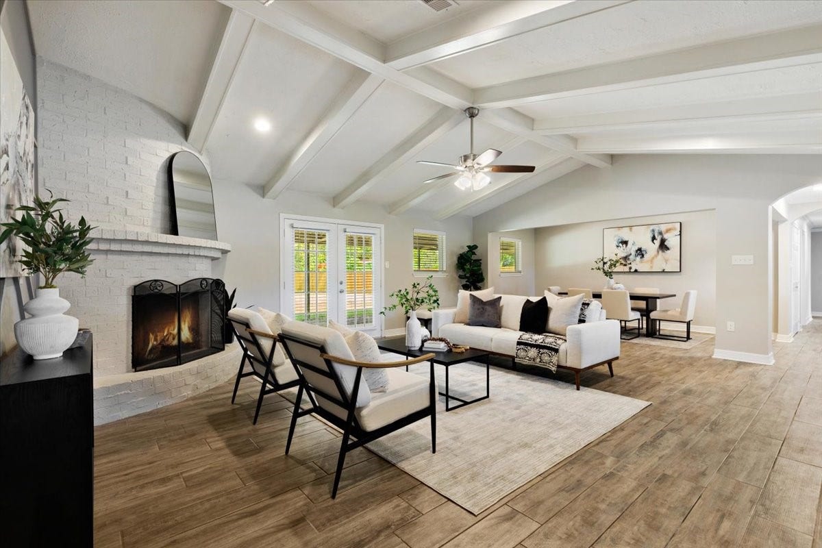 6327 Westcreek Drive, Brookside, TX 77581 Open-concept living area featuring a cozy fireplace, beautiful ceiling details, and plenty of natural light.
