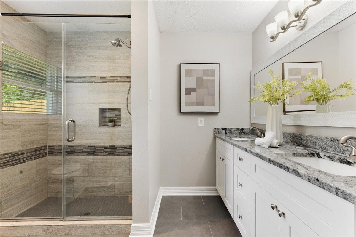 6327 Westcreek Drive, Brookside, TX 77581 Updated Primary bedroom bath featuring a spacious walk-in shower with glass enclosure,granite countertops, and double sinks.