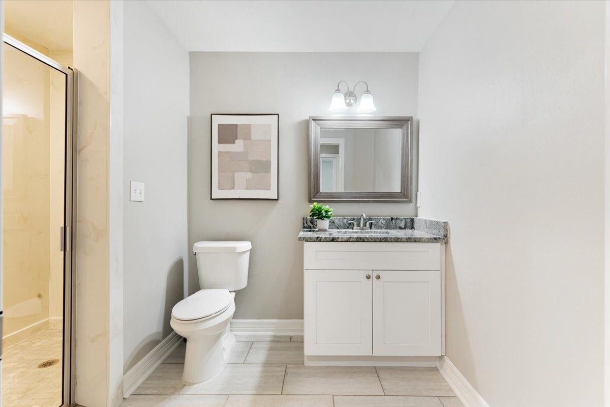 6327 Westcreek Drive, Brookside, TX 77581 Convenient bathroom in the separate mother-in-law suite featuring a vanity, mirror, and shower.