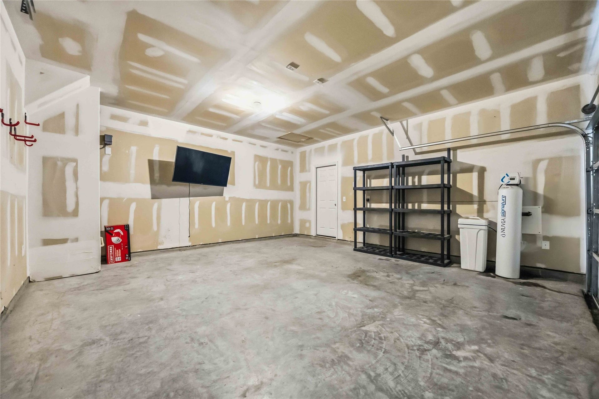 Attached two-car garage with concrete flooring.