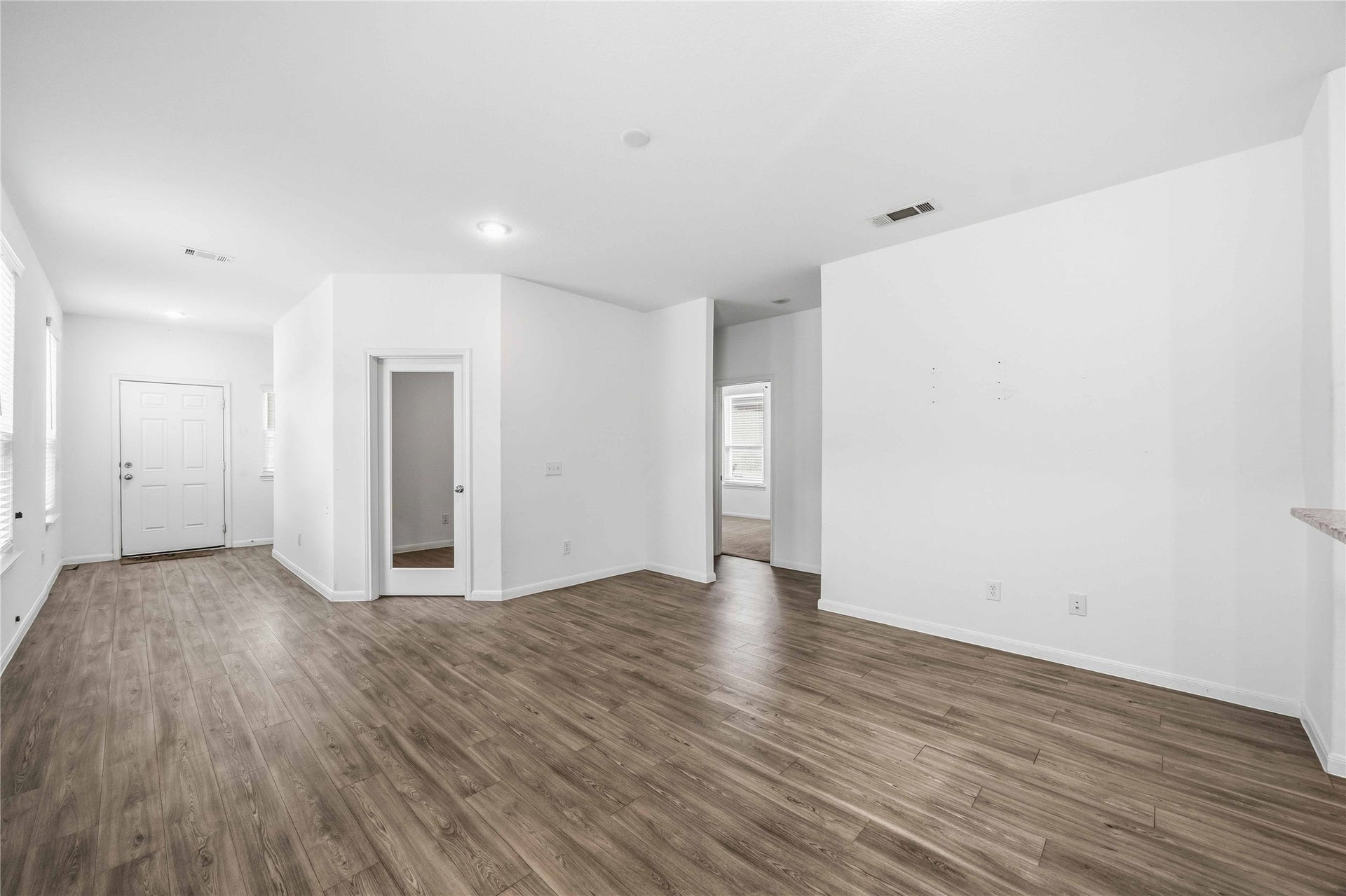 Spacious family room with an open layout and recessed lighting.