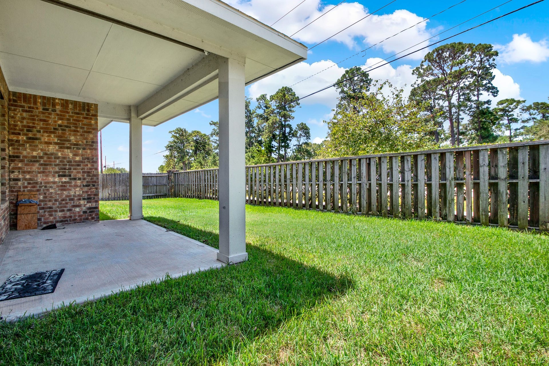 13425 Raintree Drive, Montgomery, TX 77356 The covered patio overlooks the back yard and provides a nice sitting area for relaxing evenings.