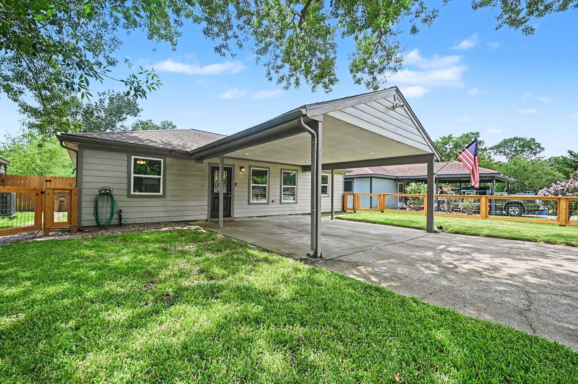4818 27th Street, Dickinson, TX 77539 The home offers covered parking that fits 2 vehicles with ease. The front yard is almost fully fenced in. A gate can be added if you desire.