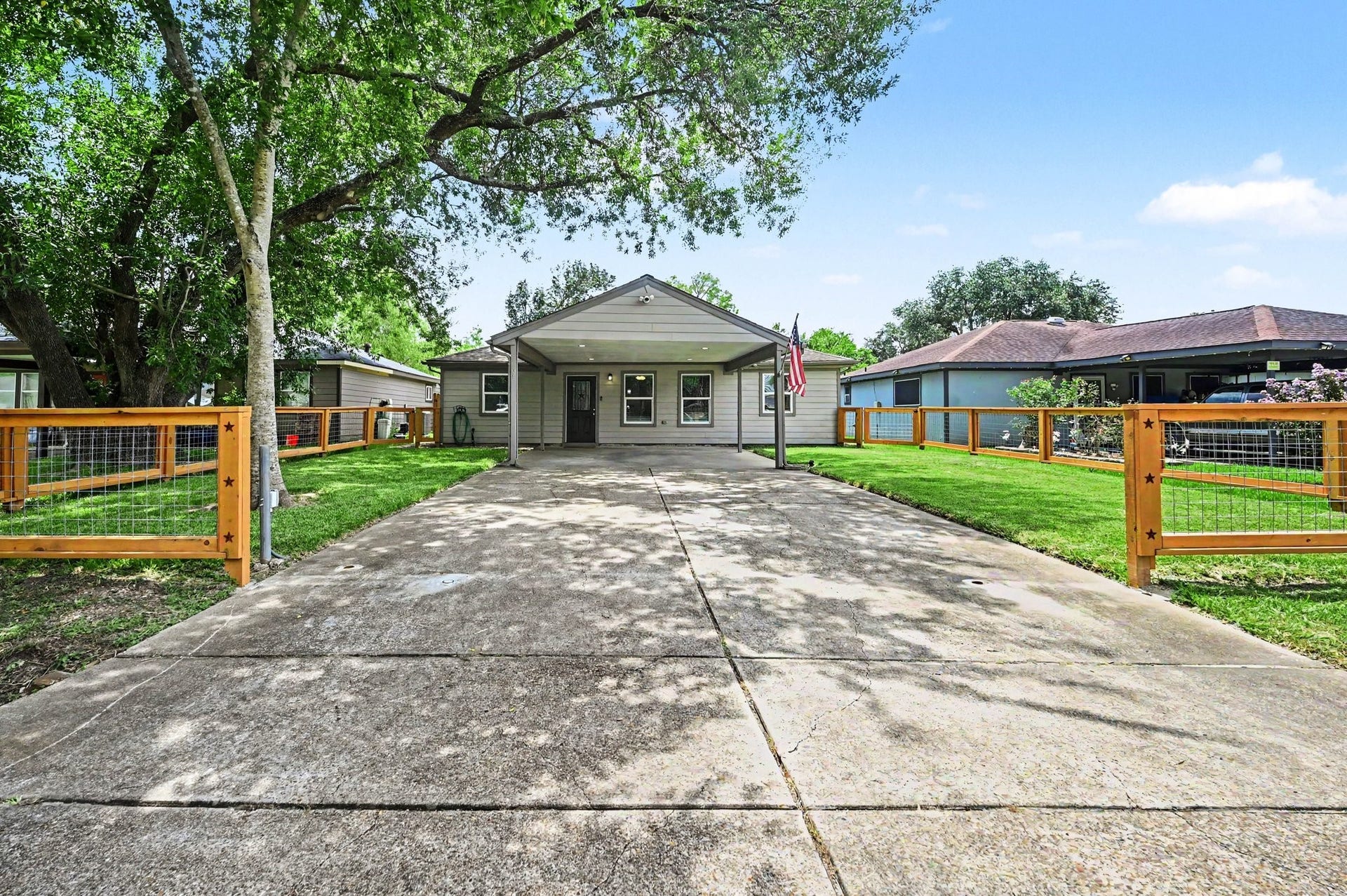 4818 27th Street, Dickinson, TX 77539 The home offers covered parking that fits 2 vehicles with ease. The front yard is almost fully fenced in. A gate can be added if you desire.