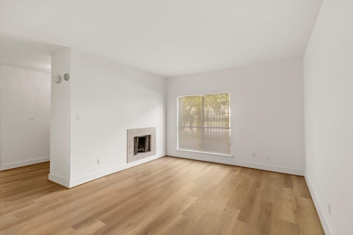 2025 Augusta Drive, #203, Houston, TX 77057 Living Area with Wood Burning Fire Place