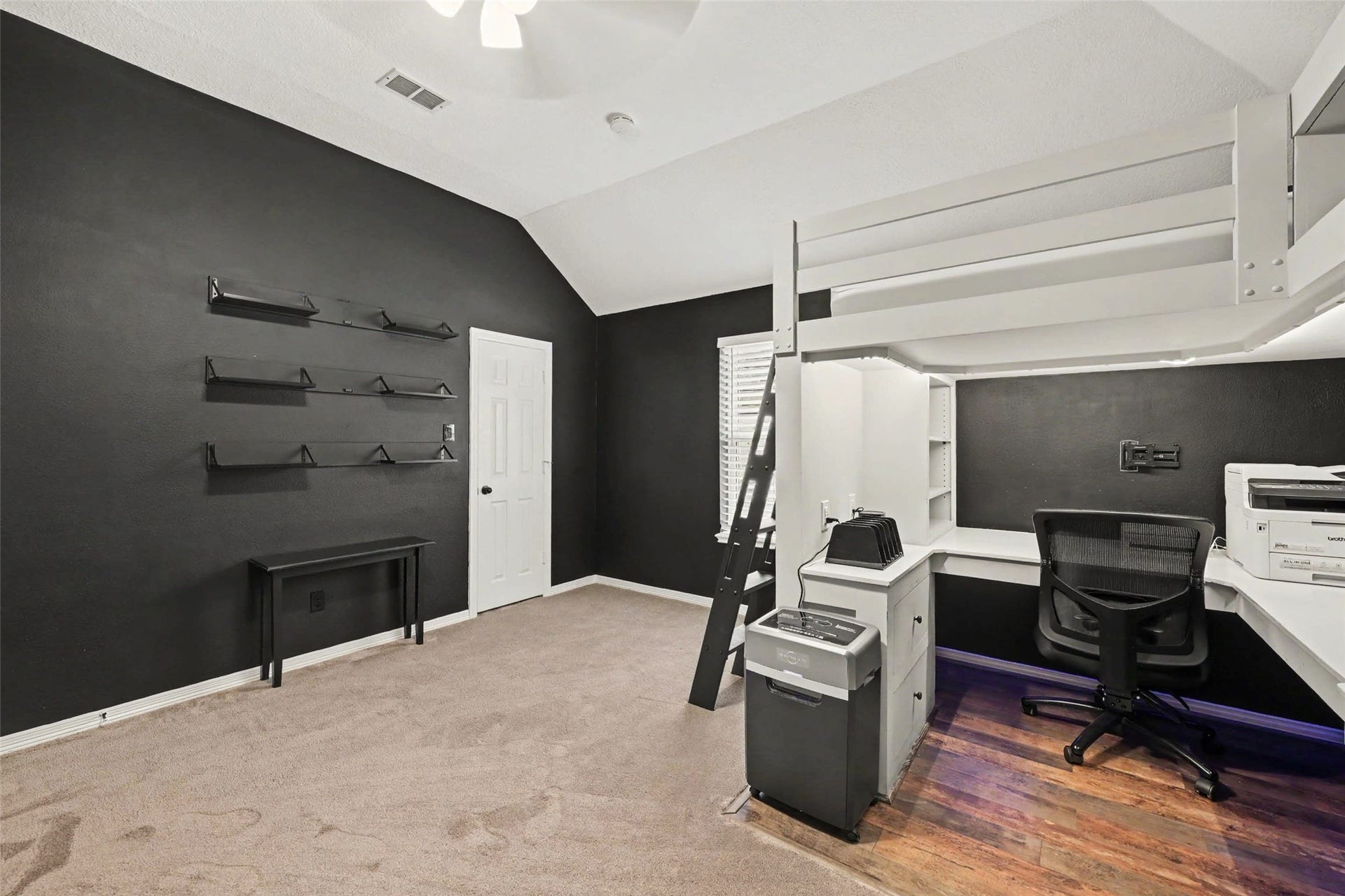 2907 Winding Shore Lane, Katy, TX 77450 A bedroom with a lofted desk area with ample workspace and a large walk in closet for storage.