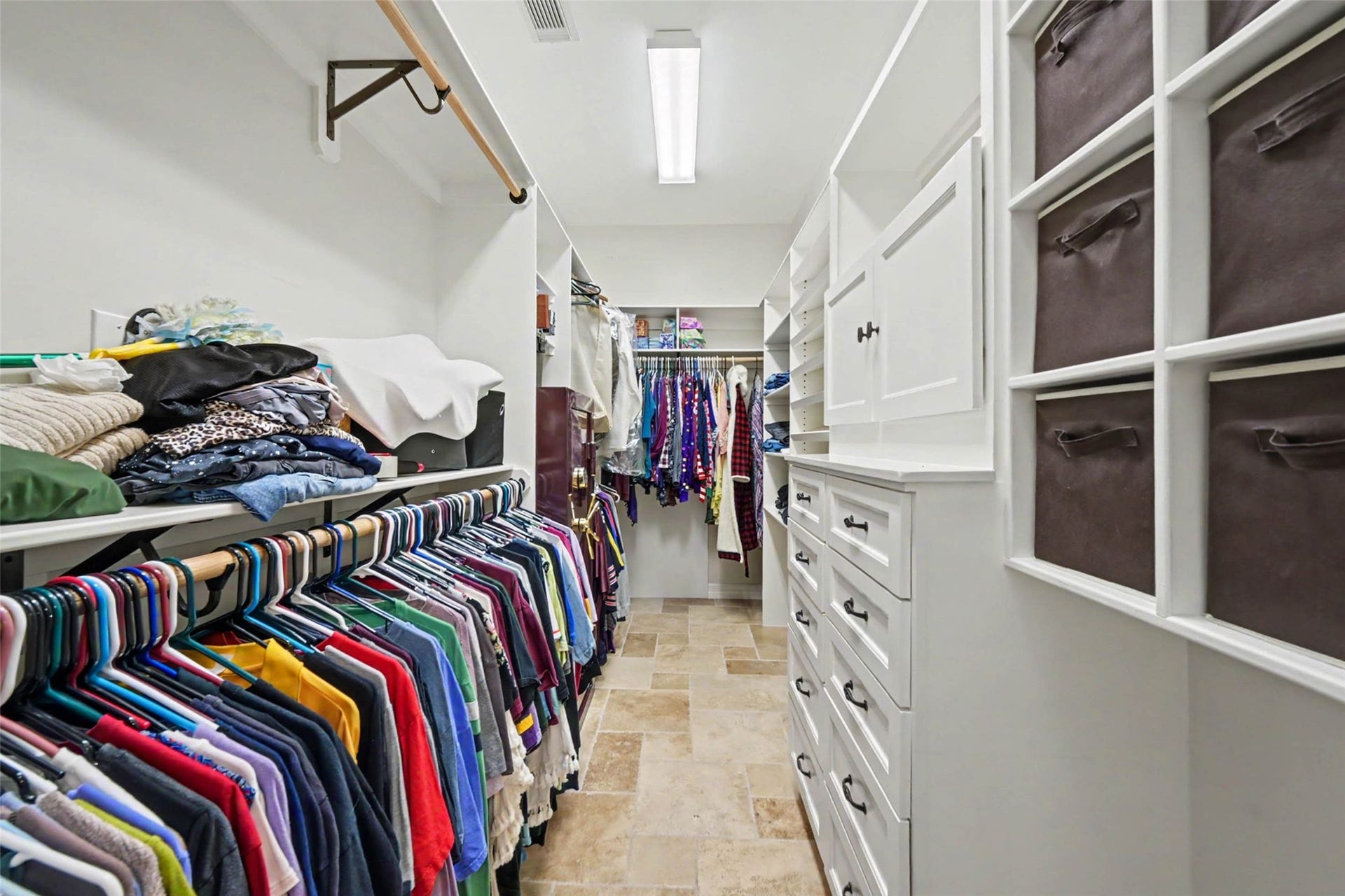 2907 Winding Shore Lane, Katy, TX 77450 Spacious walk-in closet with ample shelving, built-in drawers, and organized hanging space for all your wardrobe needs.