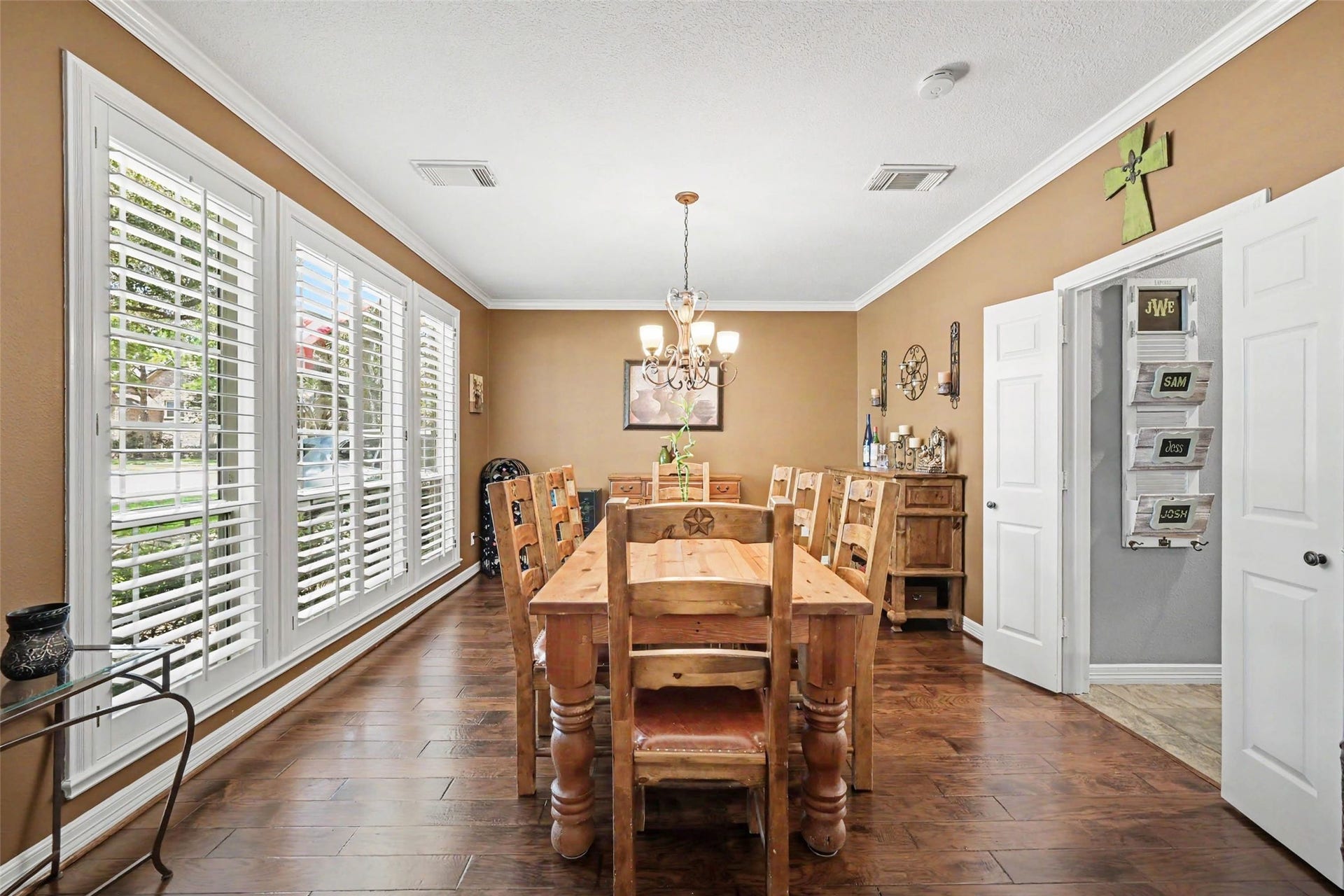 2907 Winding Shore Lane, Katy, TX 77450 Spacious formal dining room featuring elegant plantation shutters, offering an abundance of natural light and the perfect setting for gatherings and entertaining.
