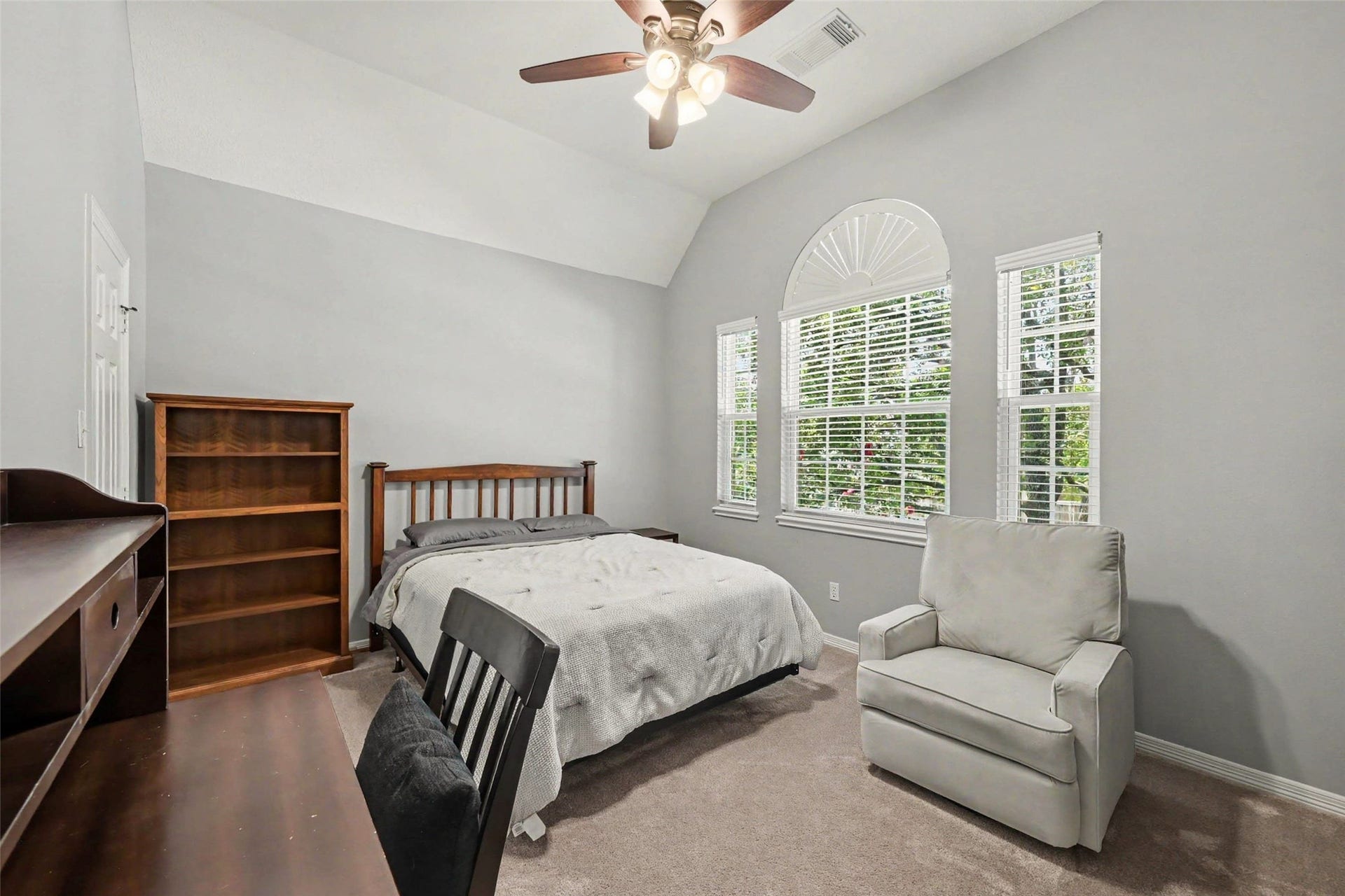 2907 Winding Shore Lane, Katy, TX 77450 Bright and inviting bedroom featuring a vaulted ceiling and a large arched window with abundant natural light.