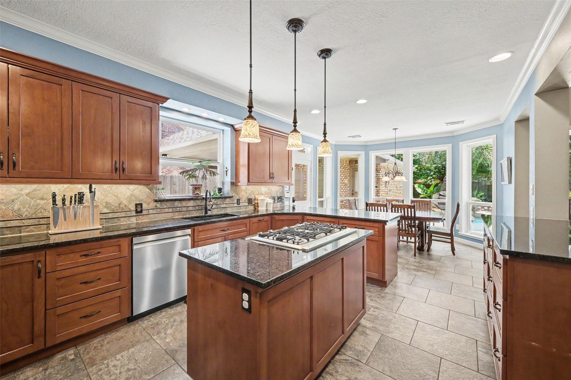 2907 Winding Shore Lane, Katy, TX 77450 The kitchen provides convenient access to the porte cochre, offering a covered entry area for added convenience and easy access to the driveway. Enjoy the seamless connection between the indoor living spaces and the beautifully landscaped backyard.
